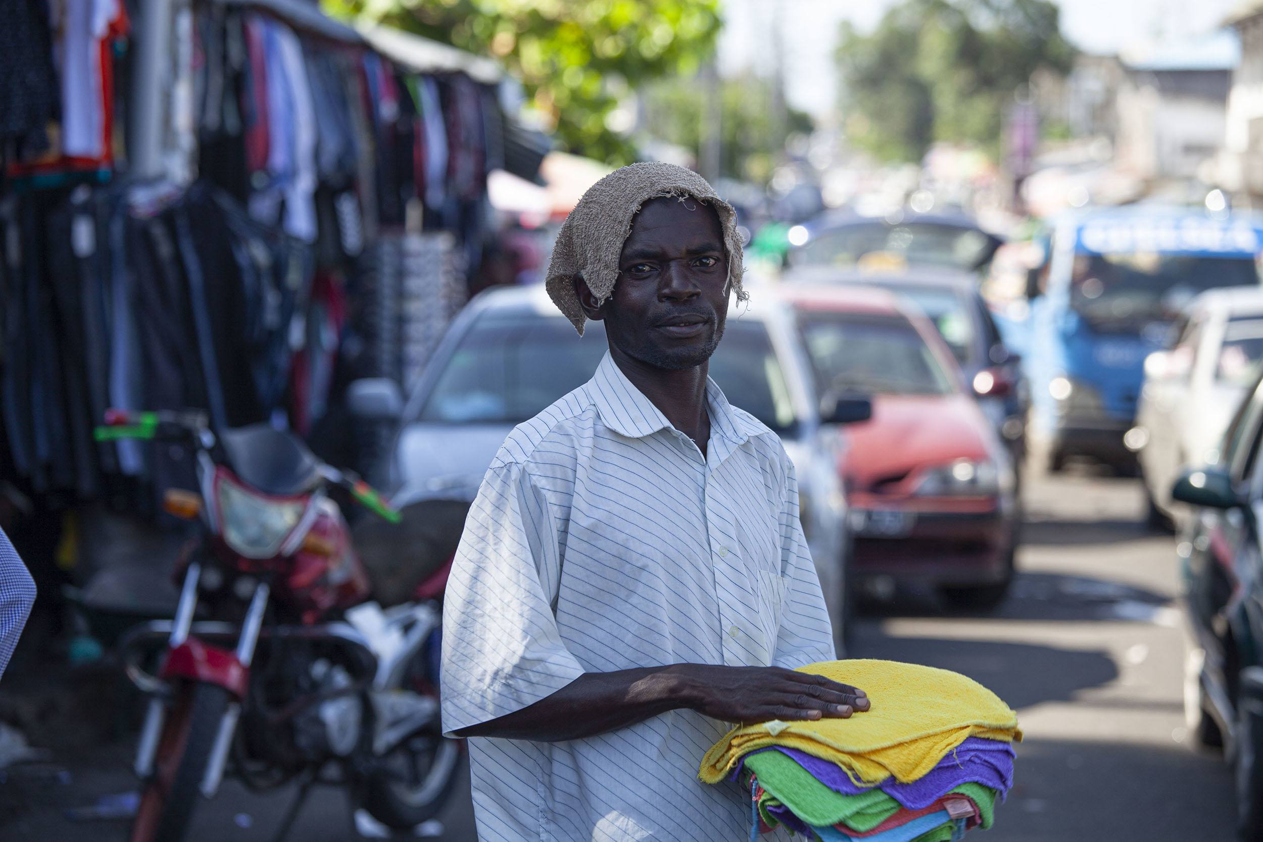 Comorian man selling goods at Volo Volo market Moroni Comoros