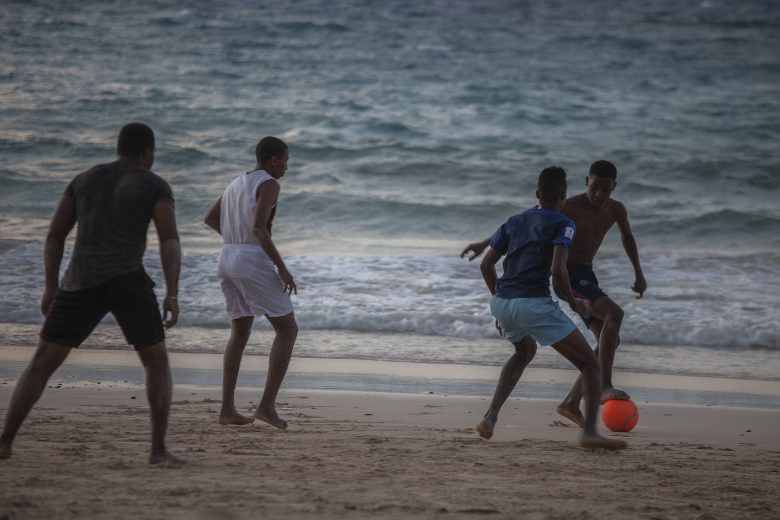 Comorian men playing beach football on Istandra Beach Moroni Comoros