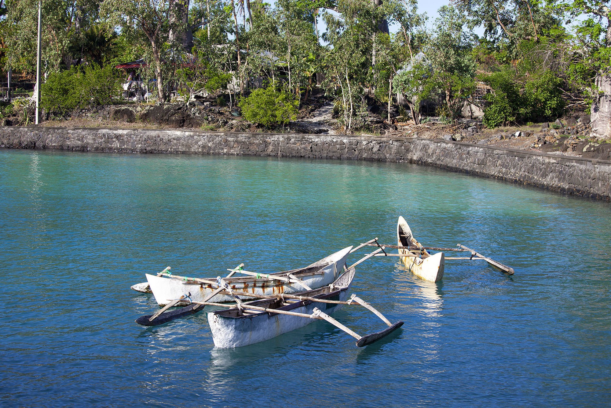 Dugout canoes in azure water at Trou du Prophete Grande Comore Comoros