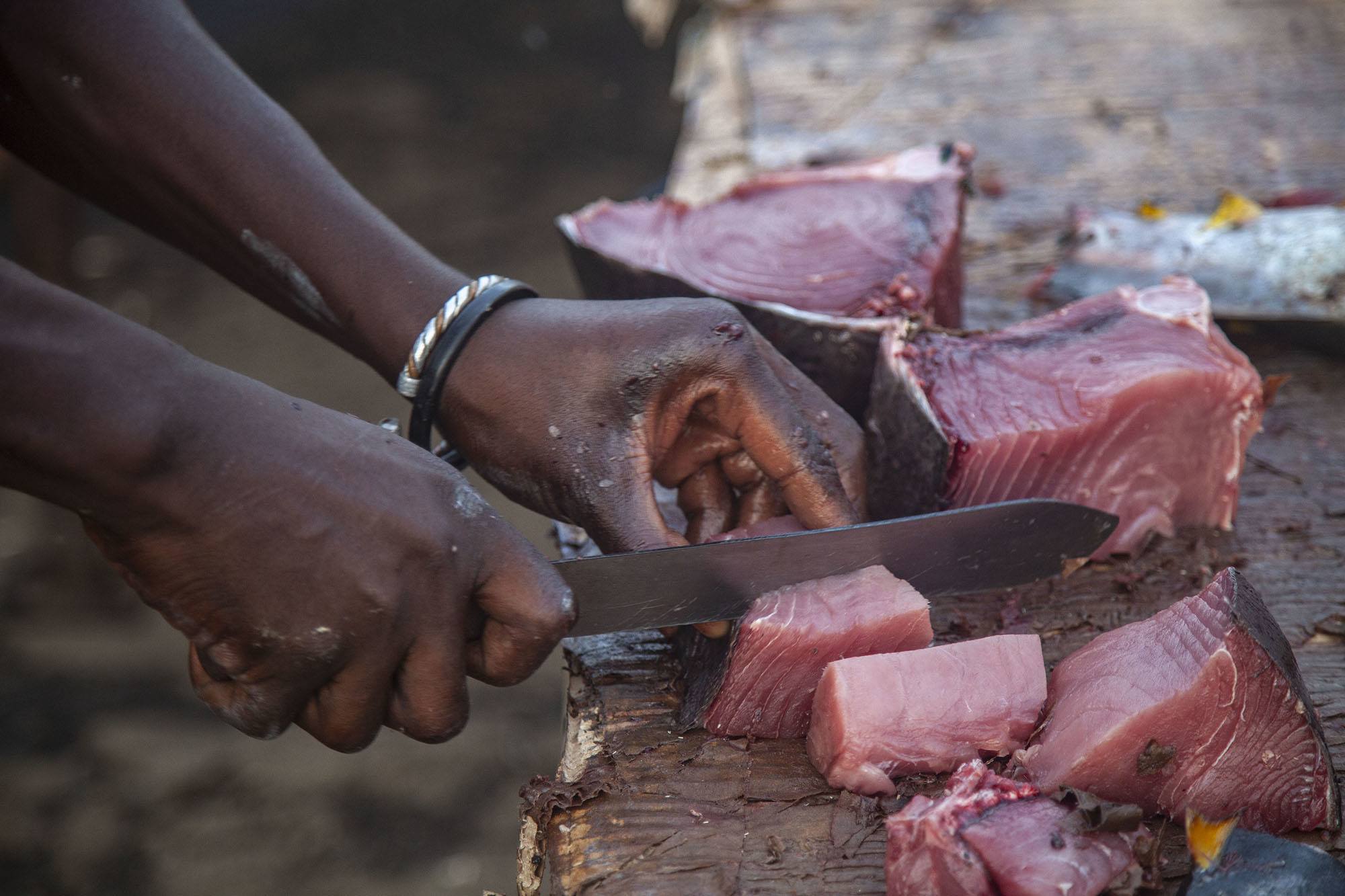 Tuna being sliced at market in Mutsamudu Anjouan Comoros