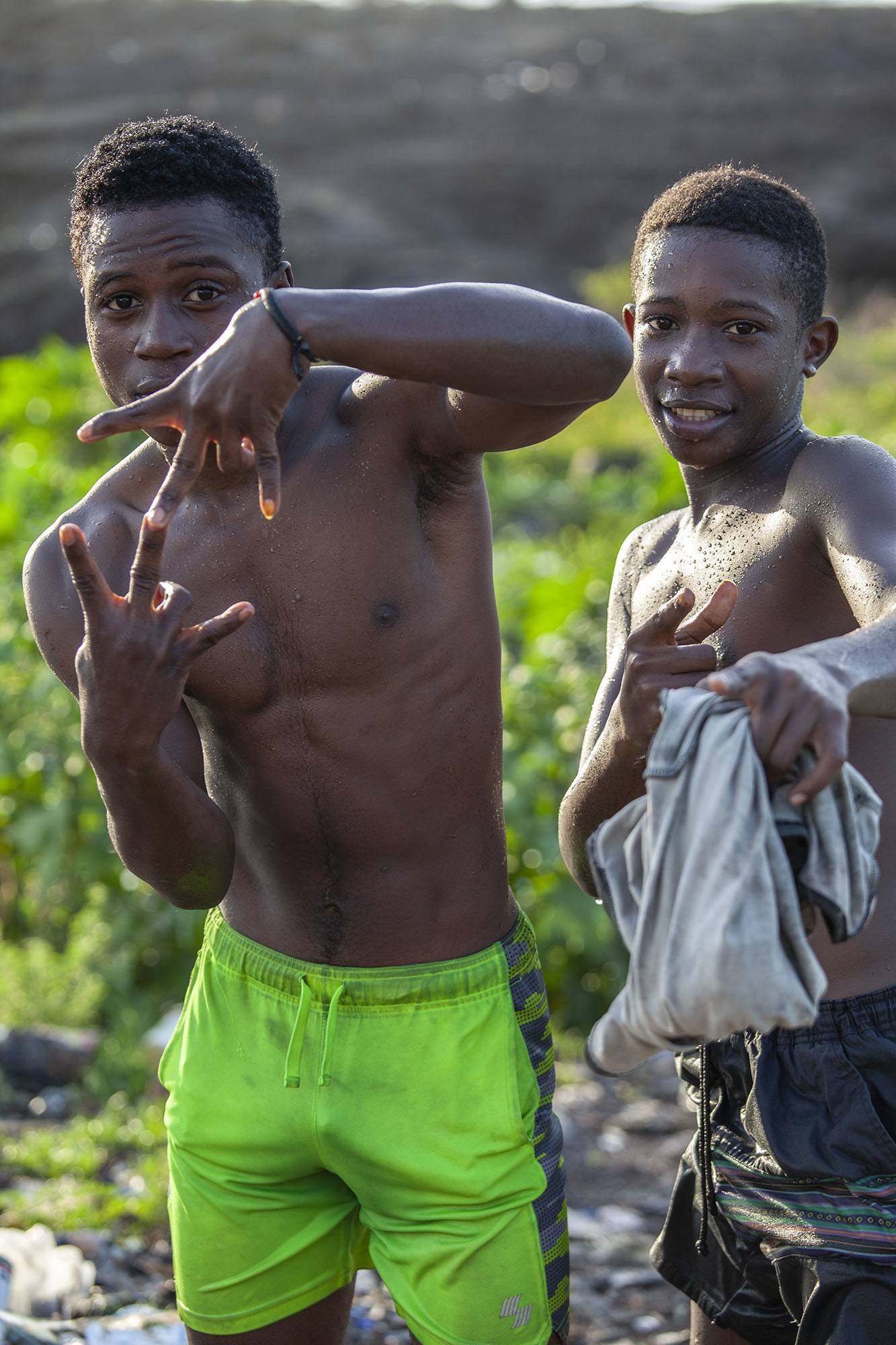 Two adolescent Comorian boys posing after swimming in rock pools in Moroni Comoros
