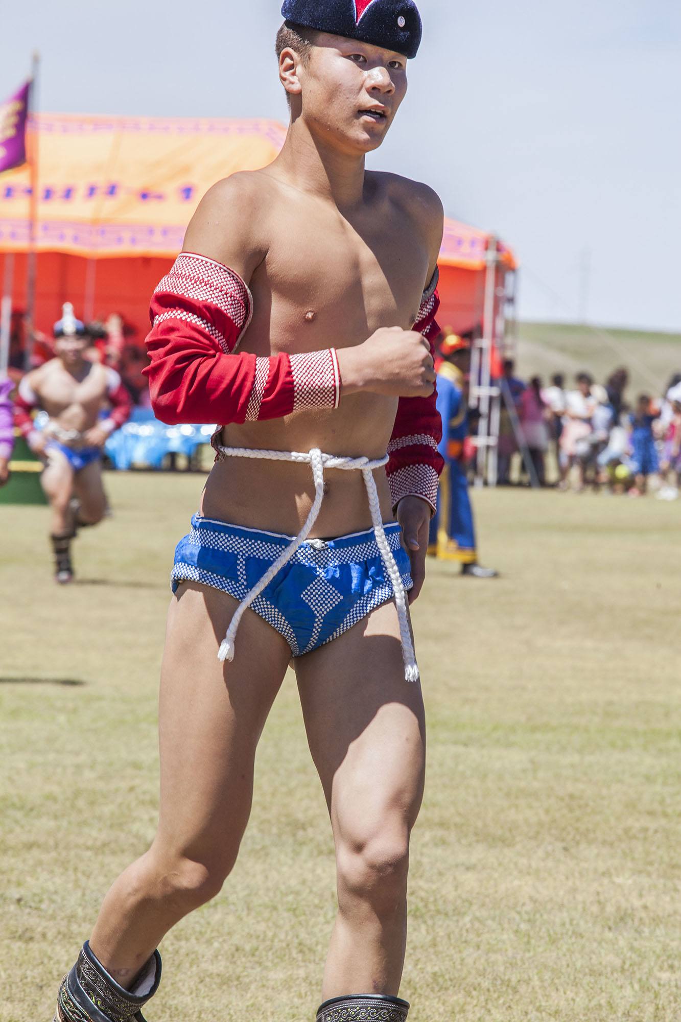 Mongolian wrestler running on field