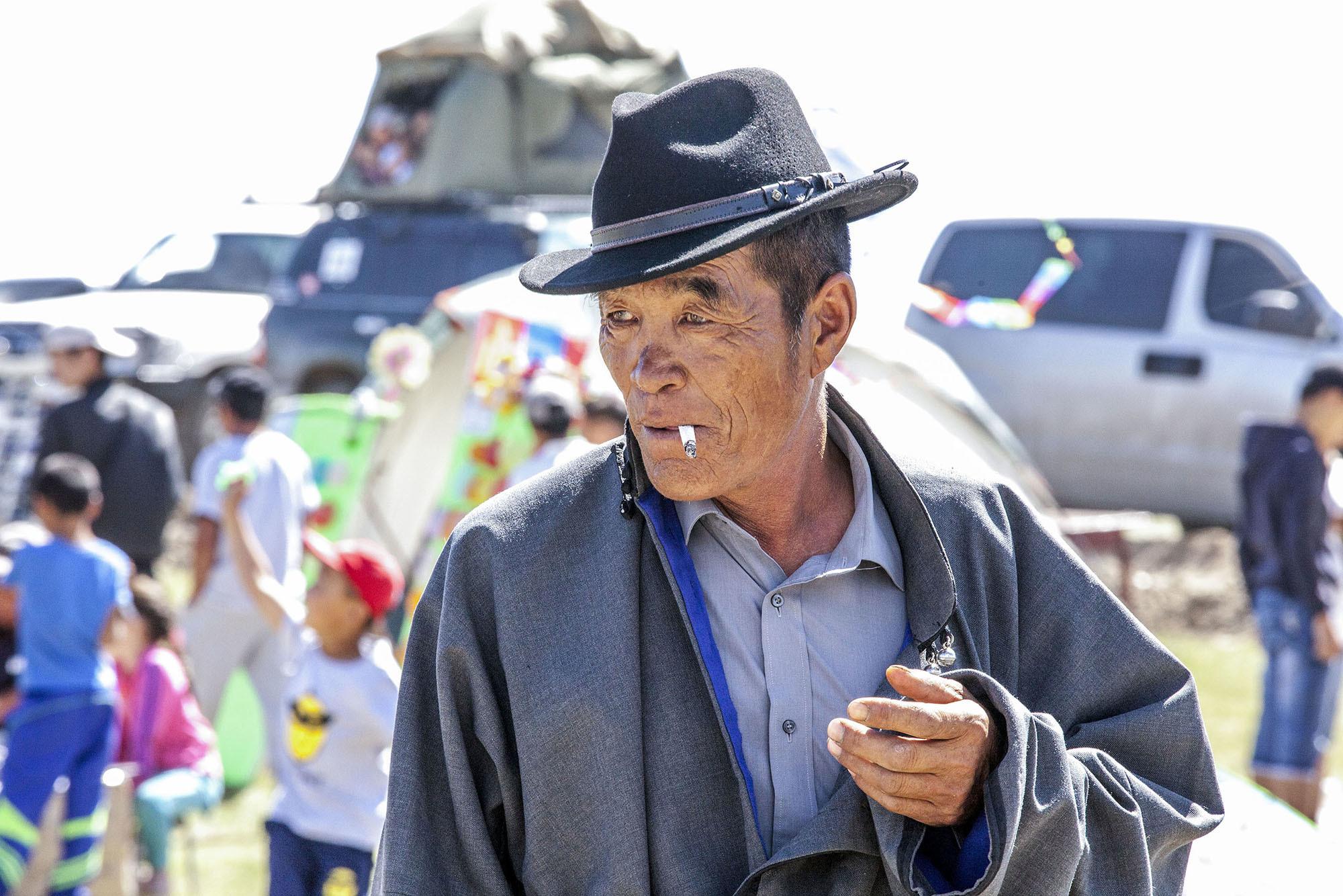 old Mongolian man smoking cigarette