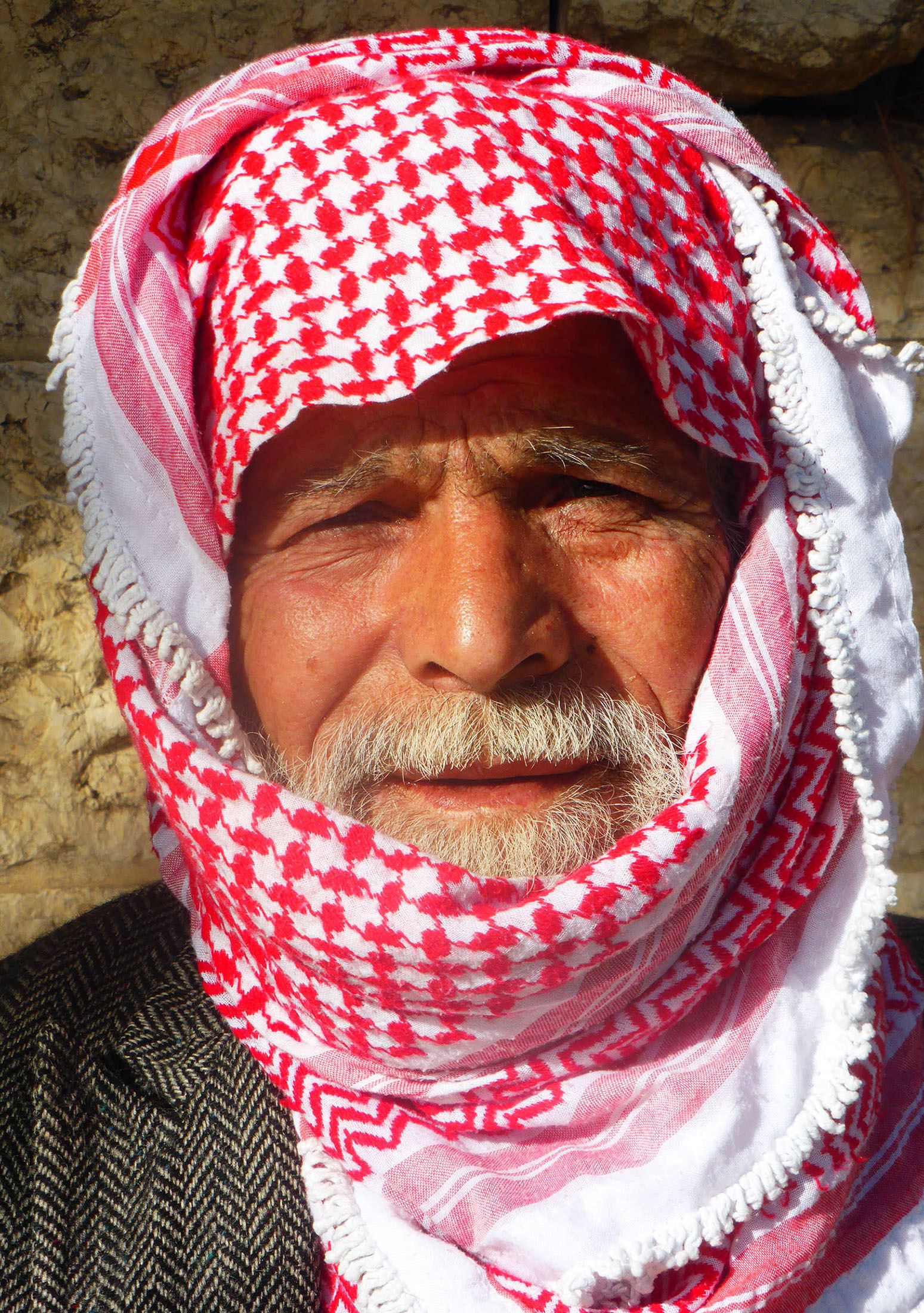 Palestinian man wearing red and white headscarf