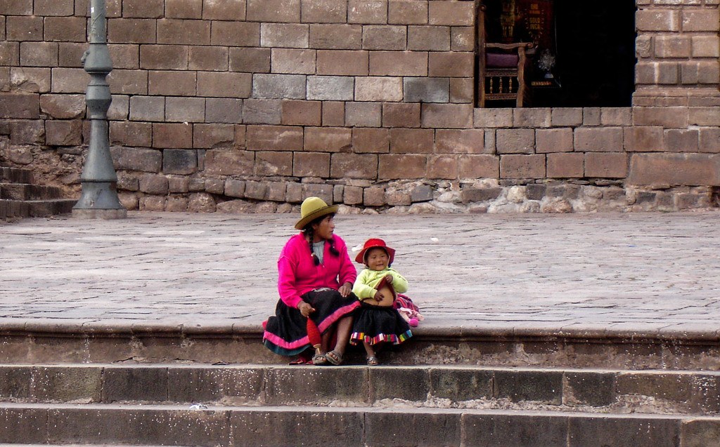 Mother and child sitting on steps in Cusco Peru