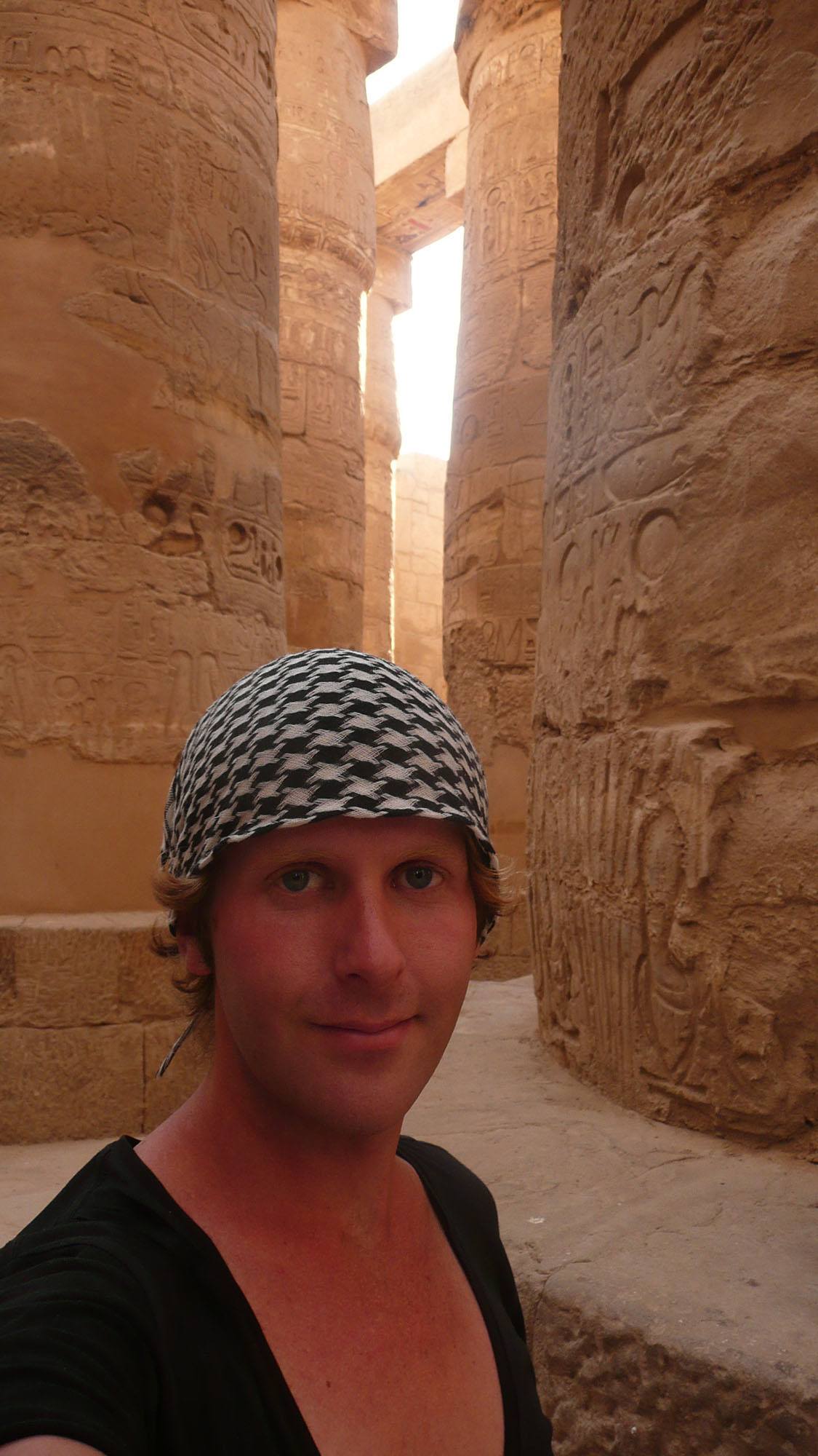 Ben between columns of Karnak temple Luxor Egypt