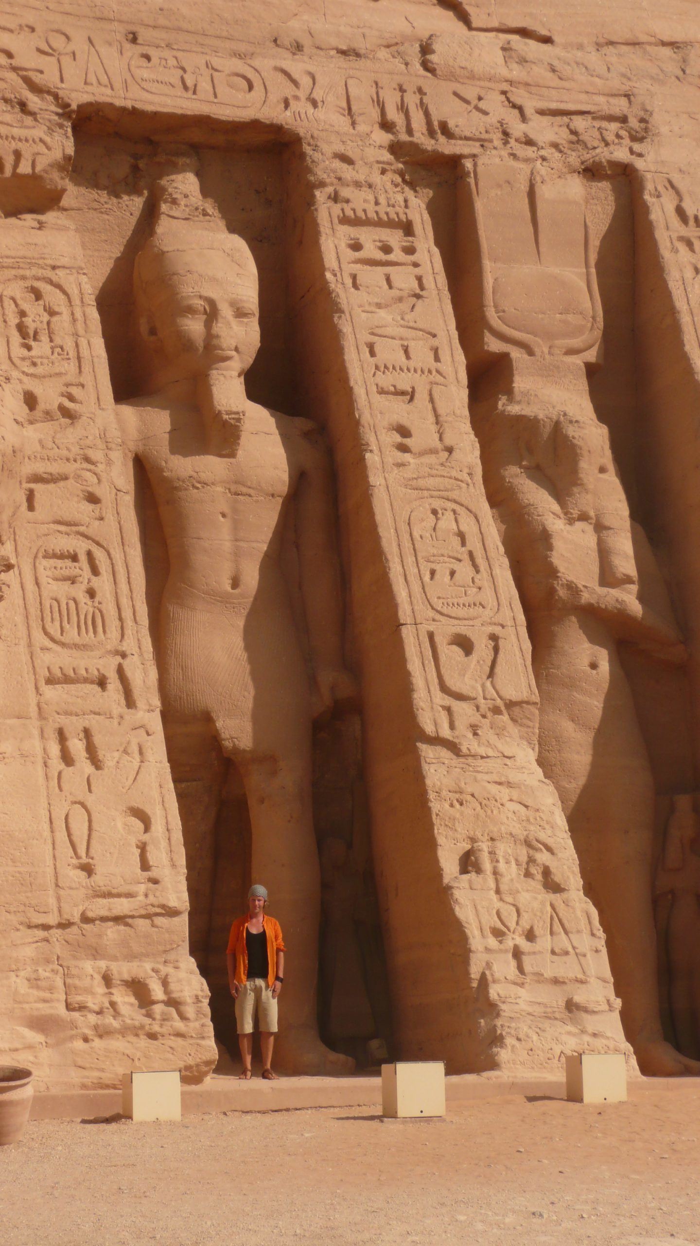 Ben in front of statues at entrance of Abu Simbel Aswan Egypt