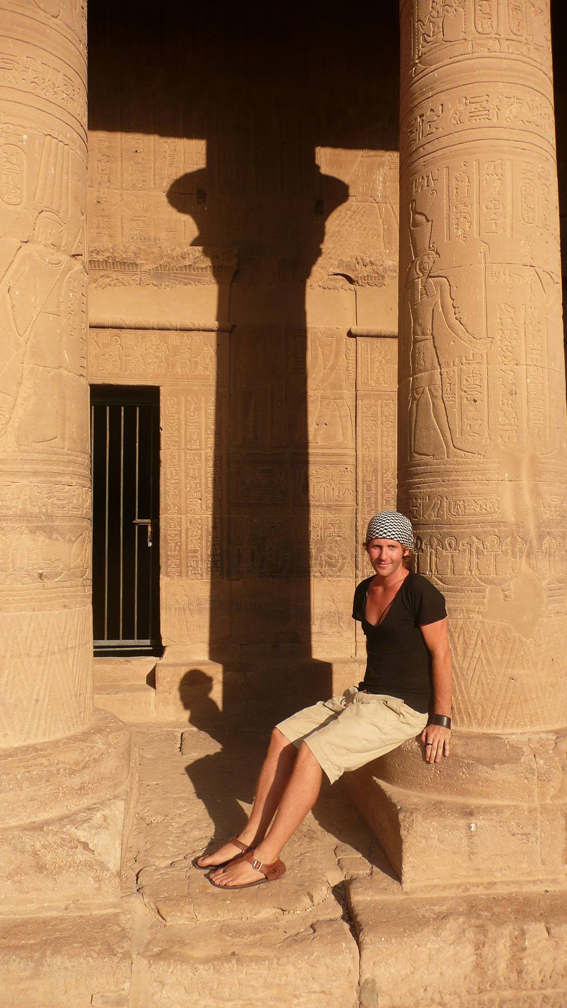 Ben sitting against column of Abu Simbel in Aswan Egypt