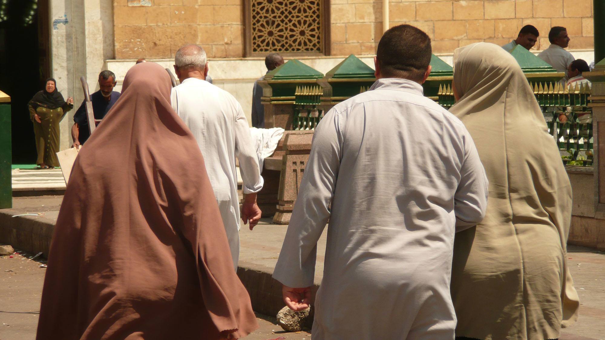 Egyptian men and women walking to mosque in Cairo Egypt