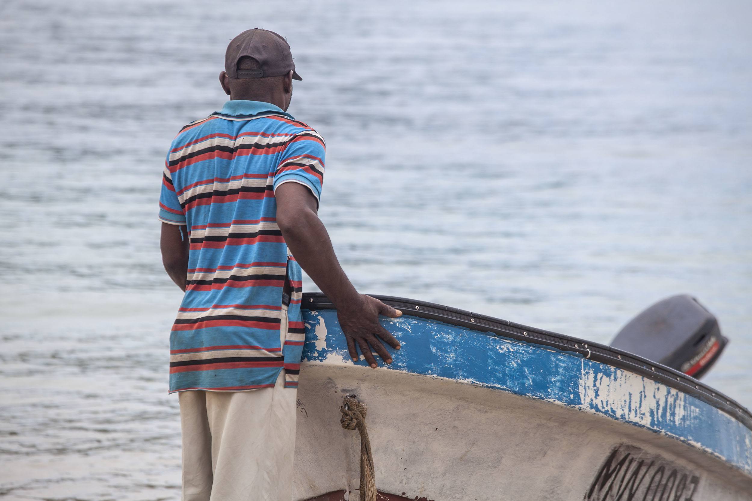Fisherman preparing boat at beach on Chissioua Ouenefou Moheli Comoros
