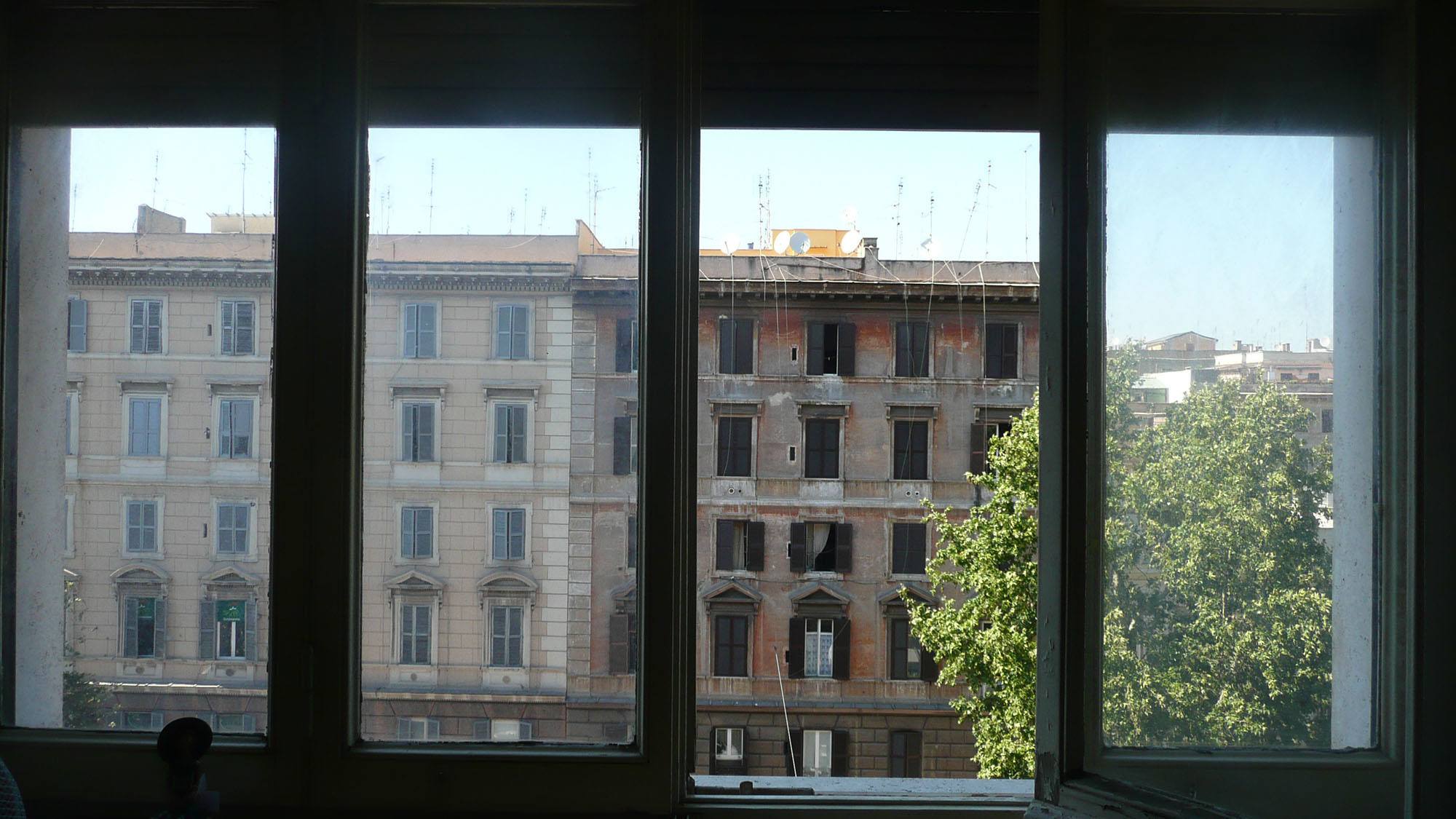 Apartment window with view of adjacent building in Rome Italy
