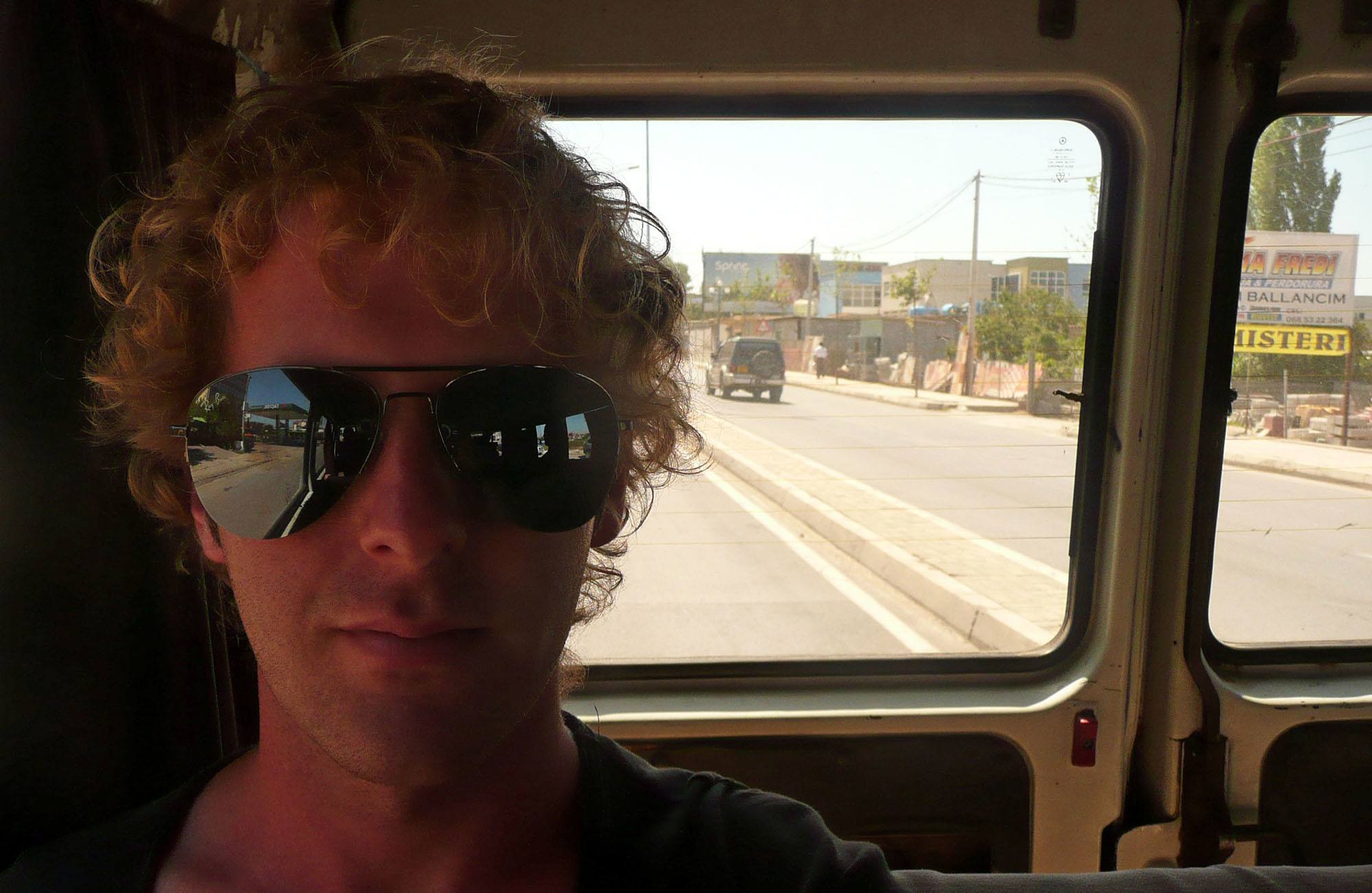 Ben in the back of a car travelling through Albania
