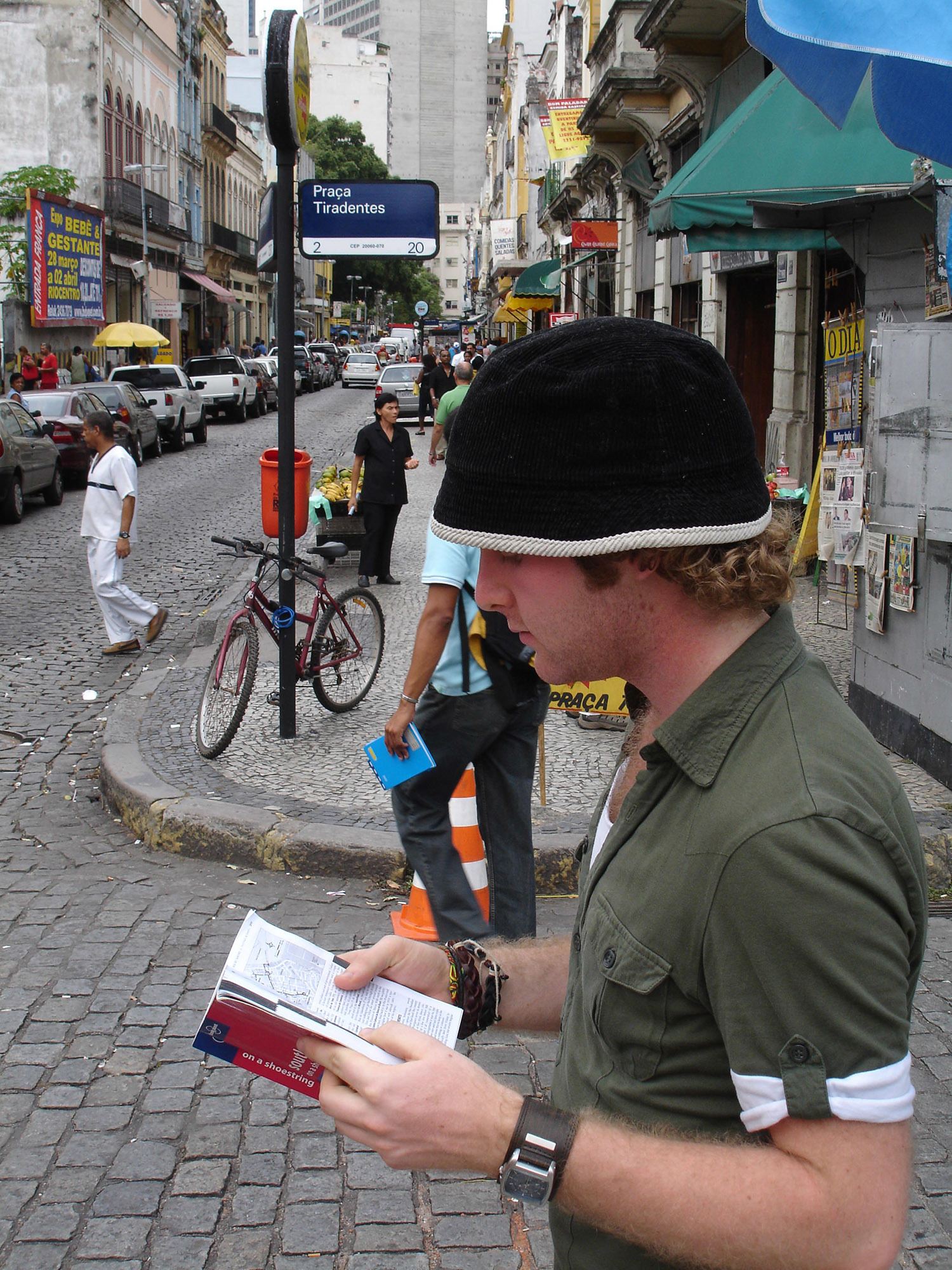 Ben reading Lonely Planet book on the streets of Rio de Janeiro Brazil