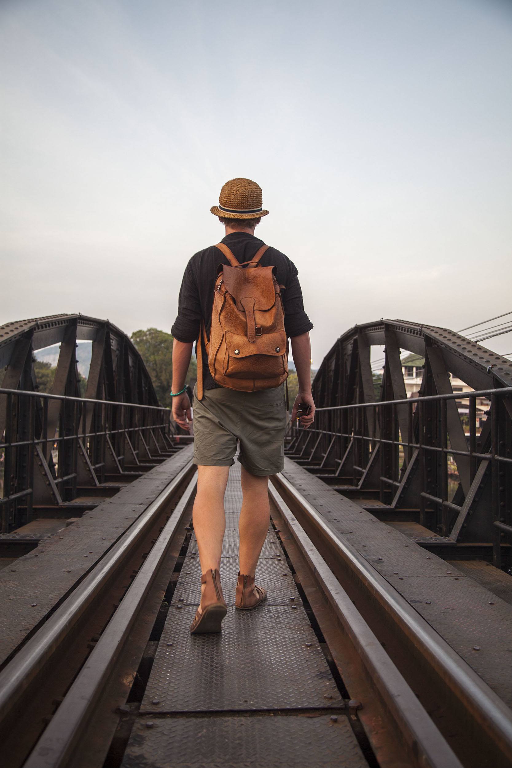 Ben walking along railway across bridge over River Kwai Kanchanaburi Thailand