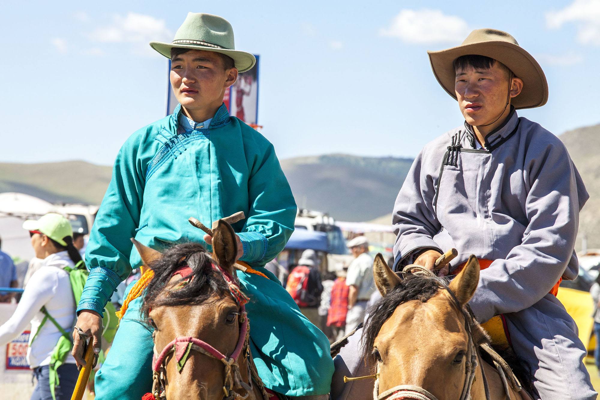 Mongolian men on horses wearning deel