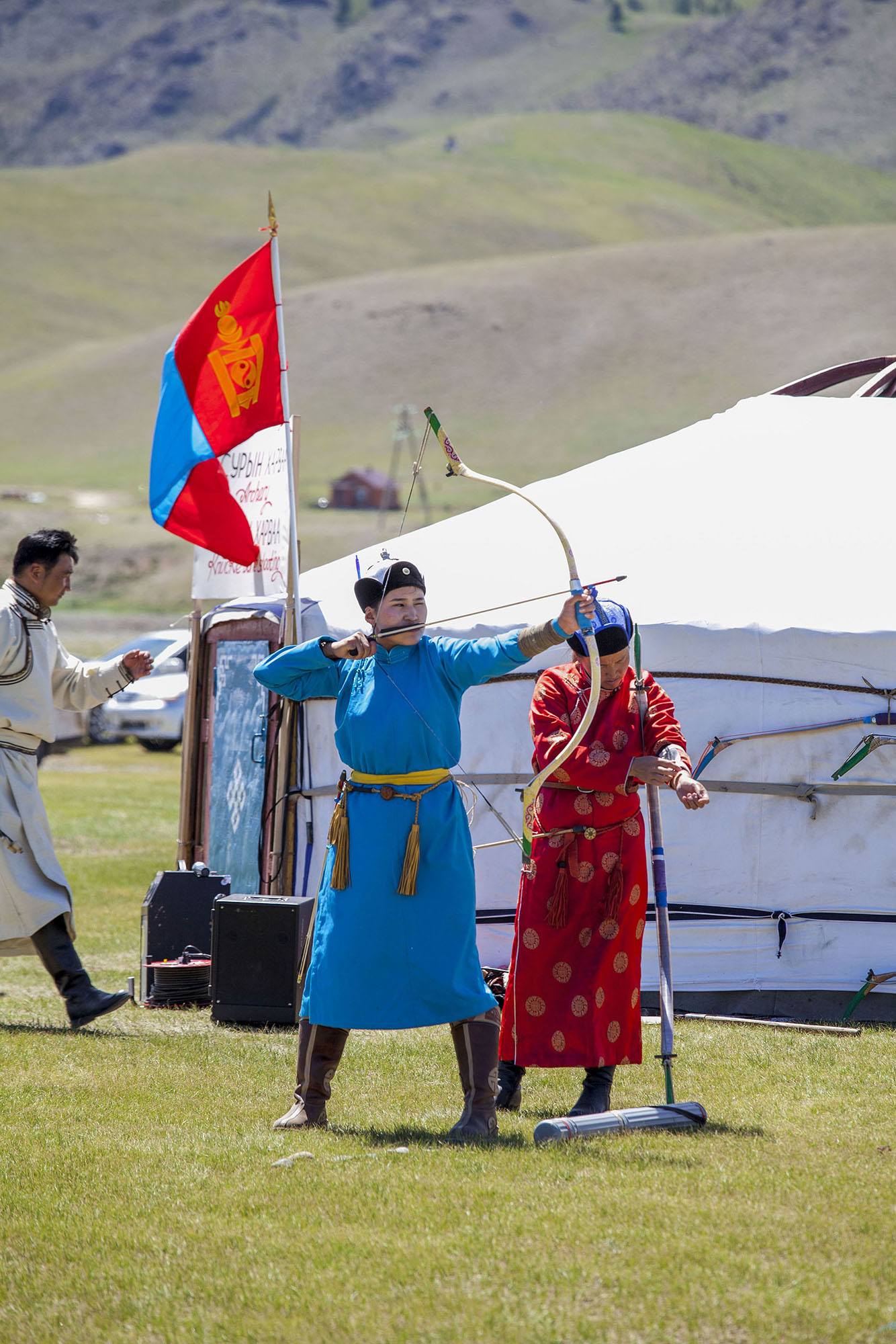 Mongolian woman playing archery at Naadam