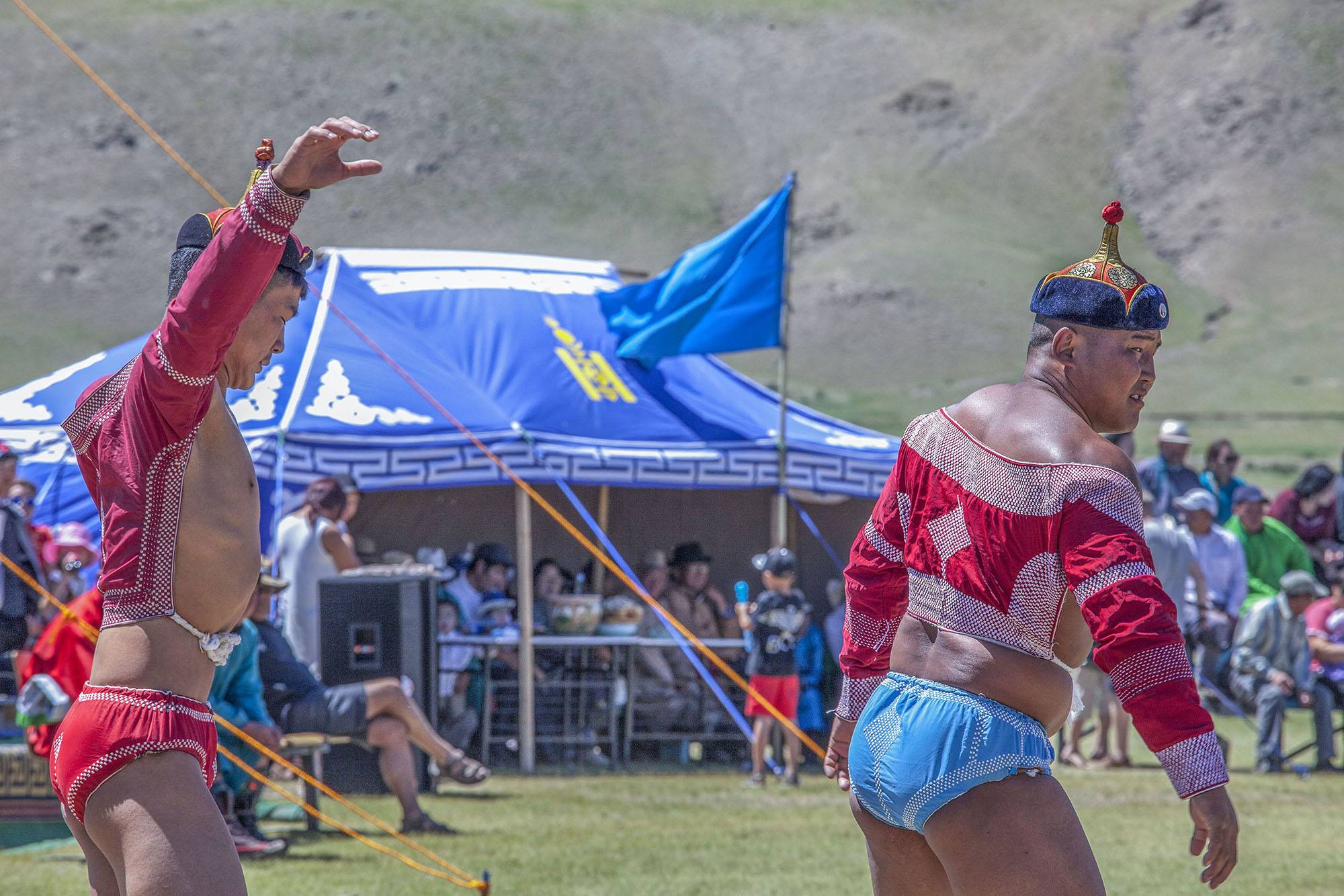 Mongolian wrestlers performing buh tavih