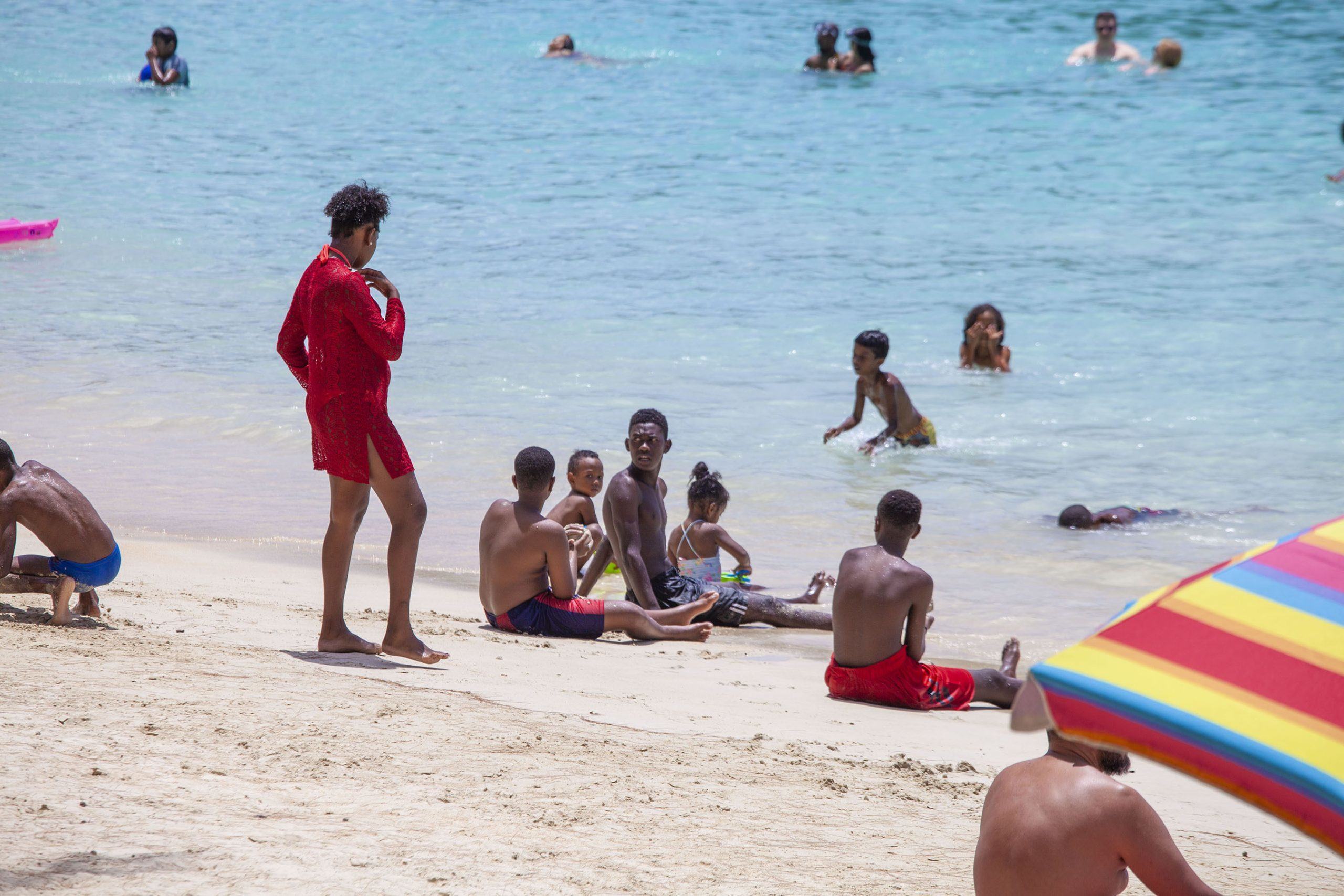 people sitting on sand Pereybere beach Mauritius