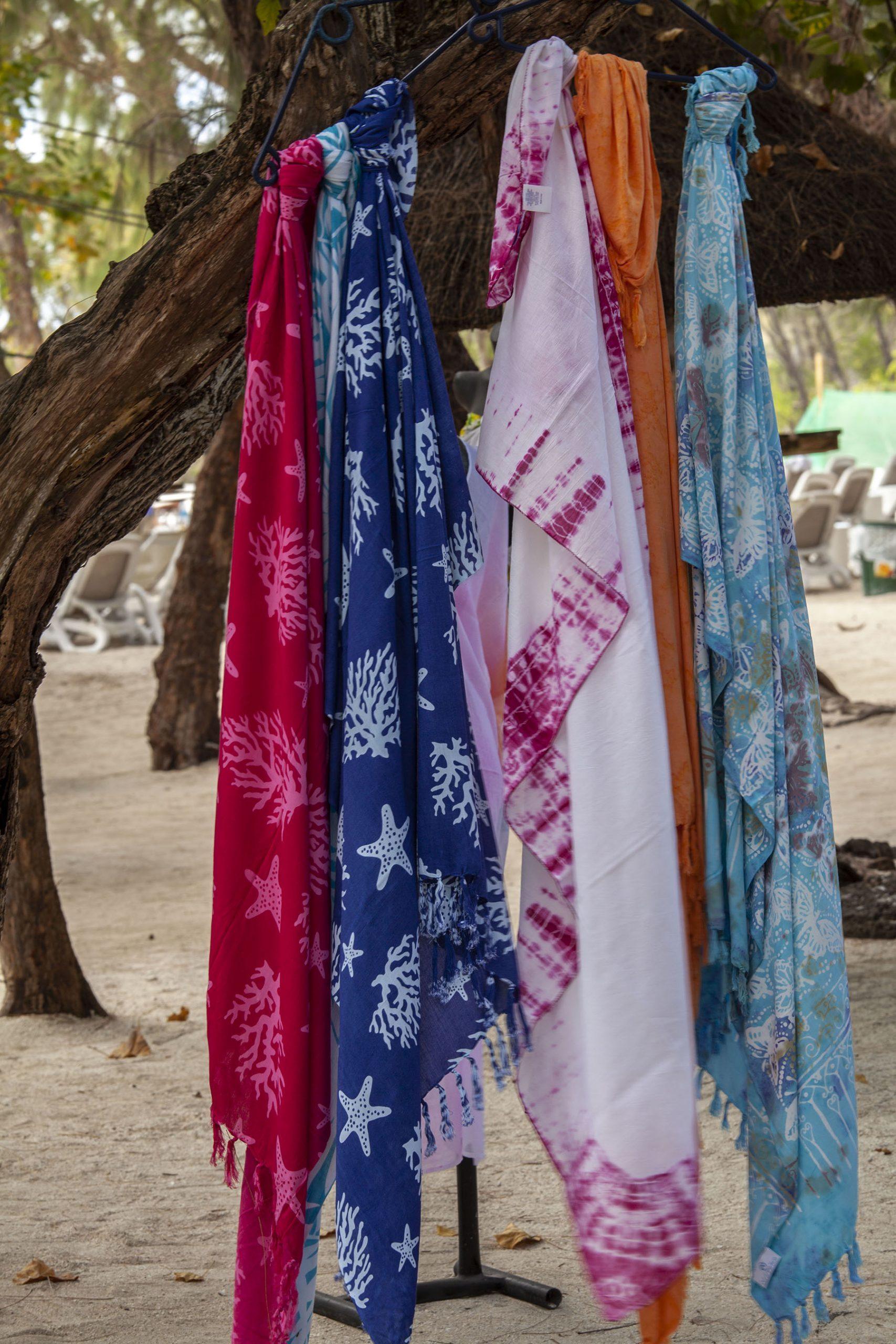 sarongs hanging from tree branch Ile des Cerfs Mauritius