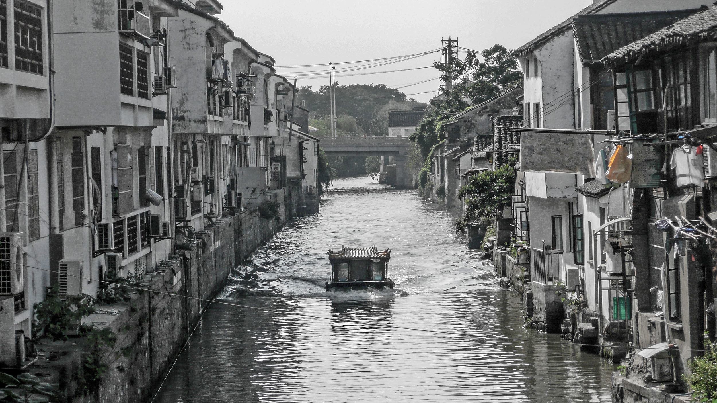 A boat moving along the canals of Suzhou China