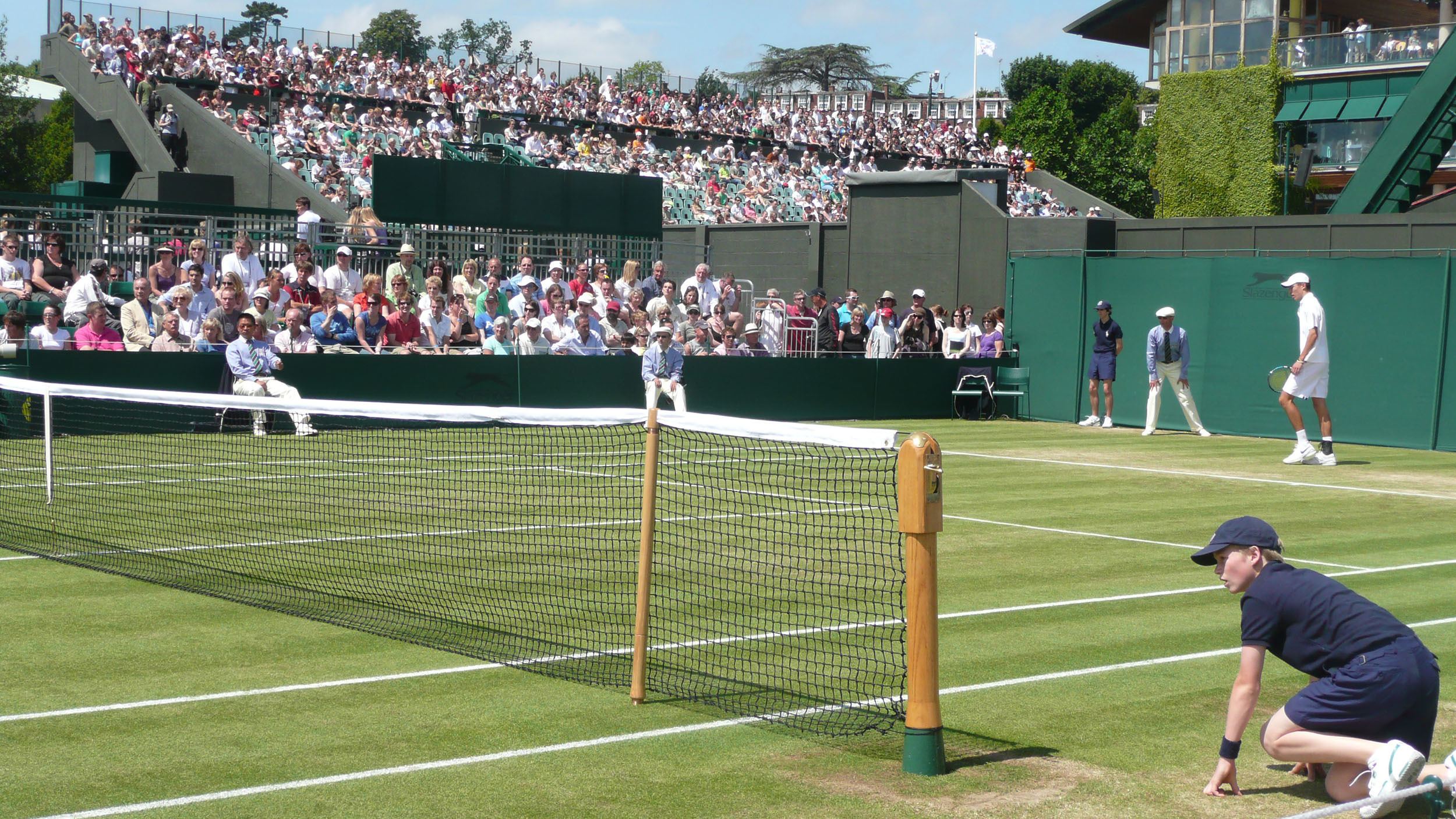 Ball boy squatting by a court at Wimbledon London England United Kingdom