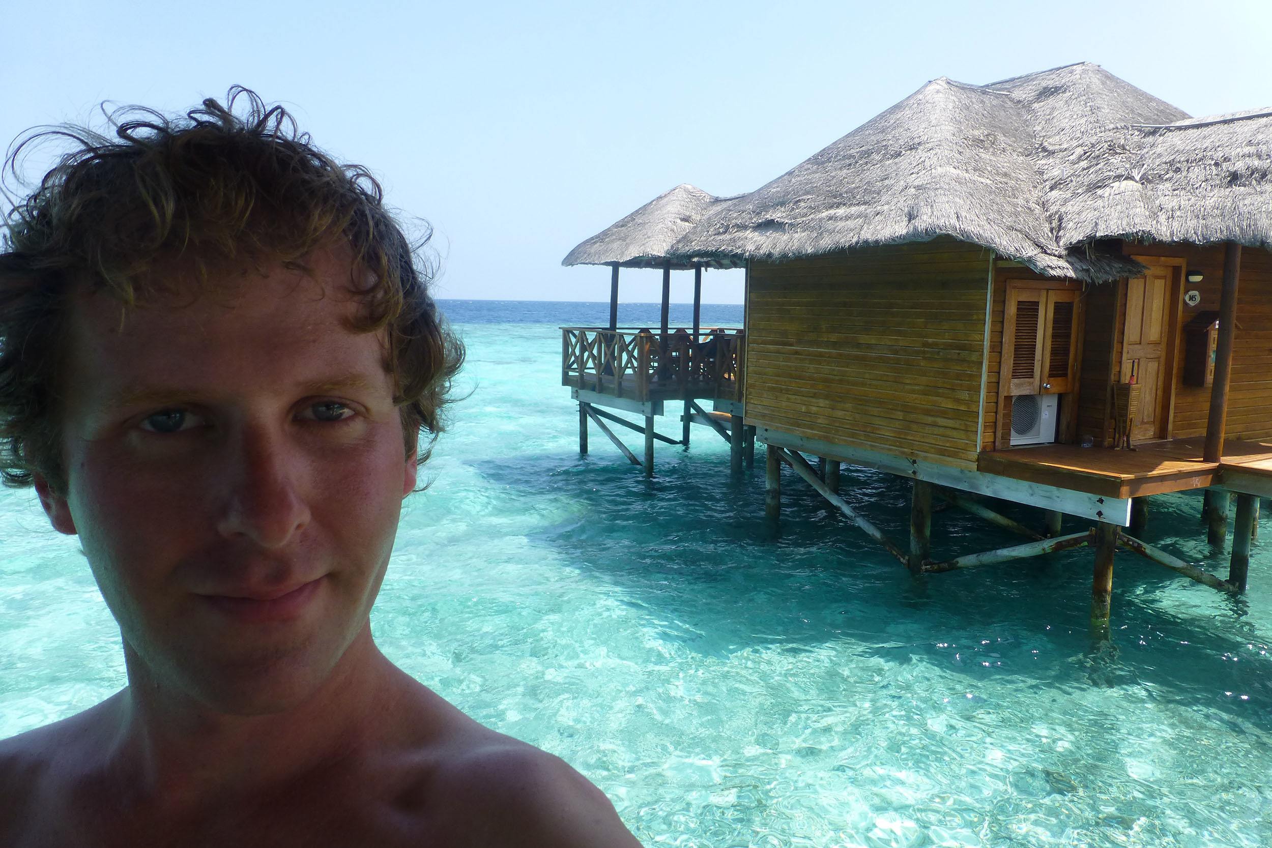 Ben beside overwater bungalow on Fihalhohi the Maldives