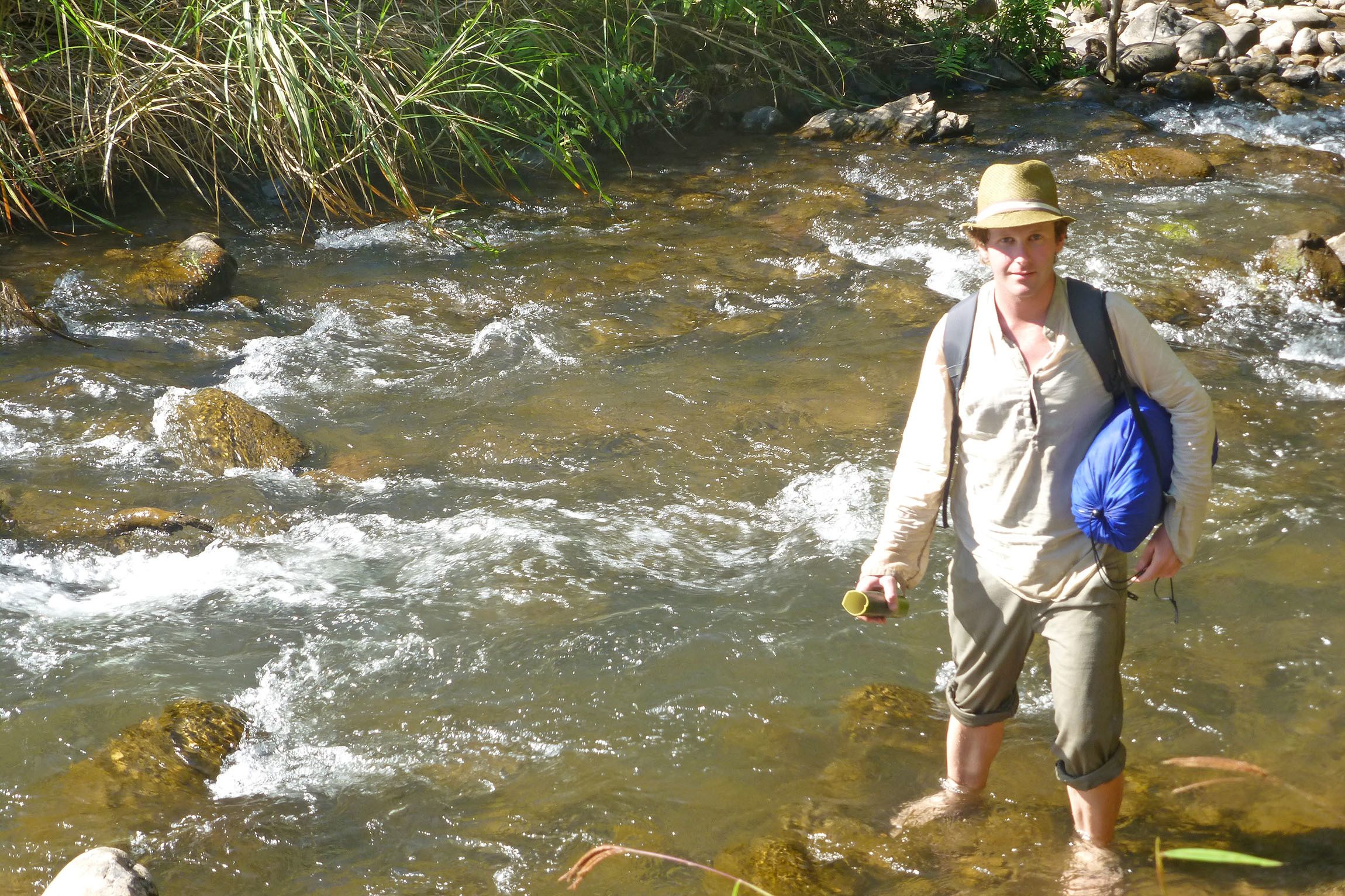 Ben crossing a river in the Laotian jungle Laos