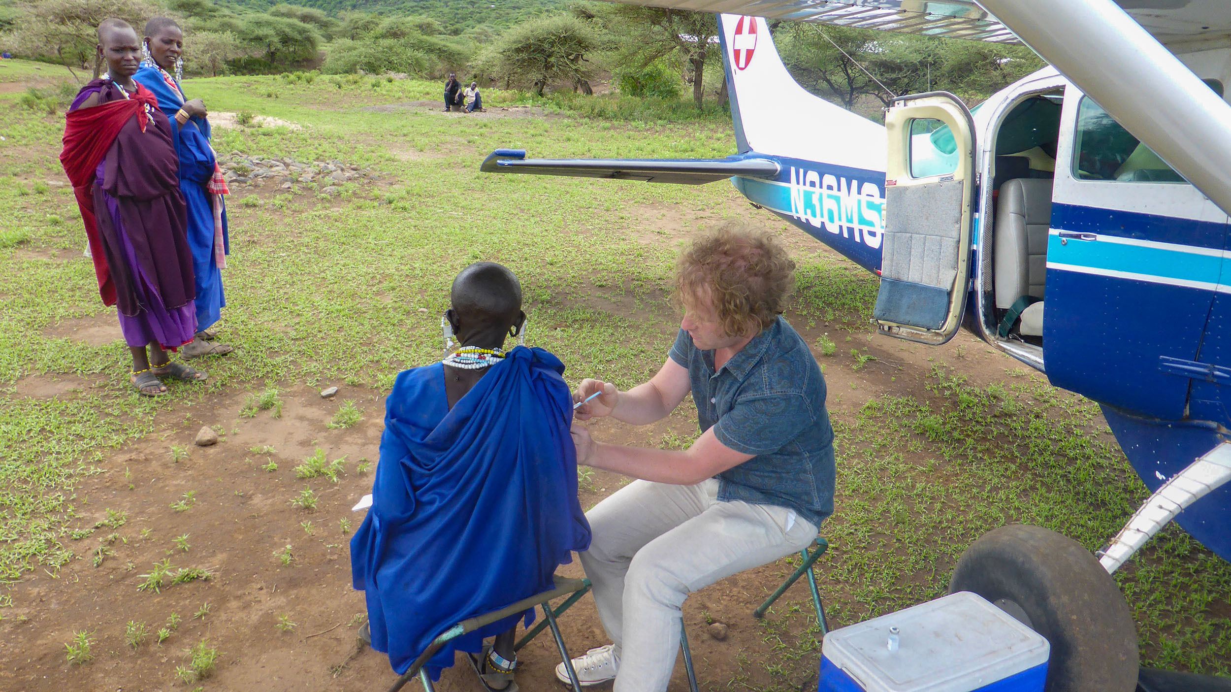Ben giving immunisation to Maasai woman with Wings of Hope in Tanzania