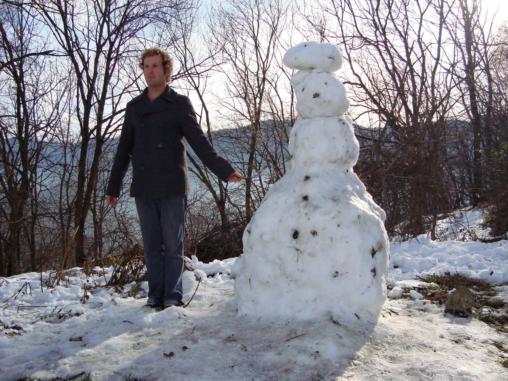 Ben holding stick hand of snowman in Brasov Romania