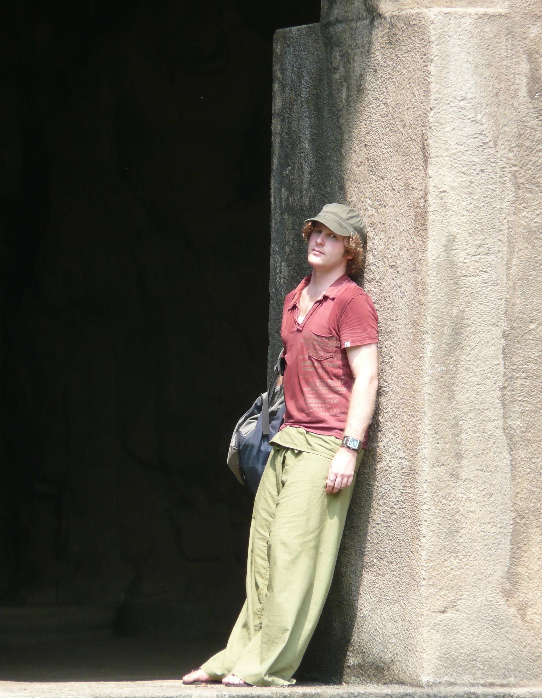 Ben leaning against column of building on Elephanta Island Mumbai India closeup