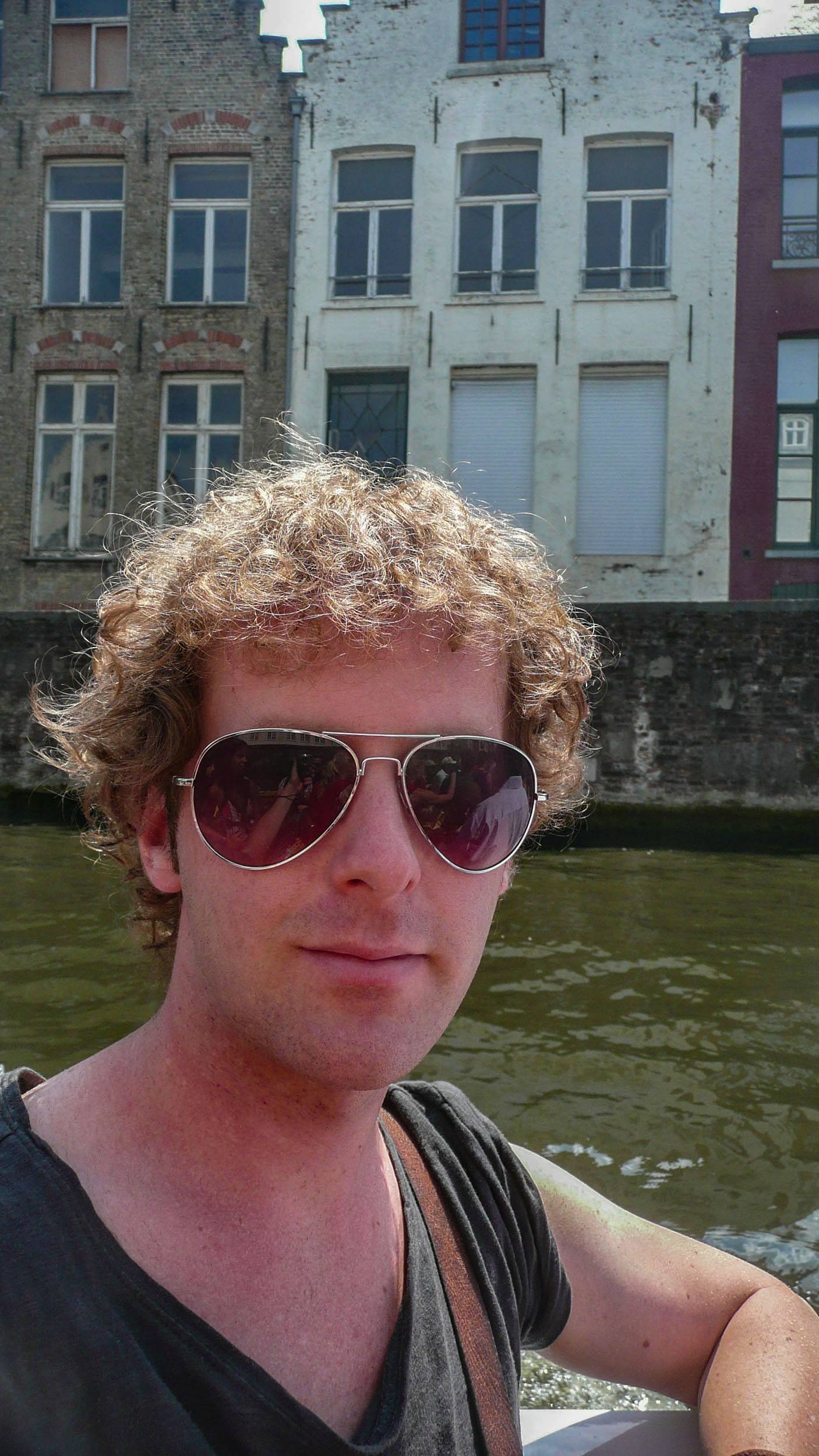 Ben on boat tour along canals of Bruges Belgium