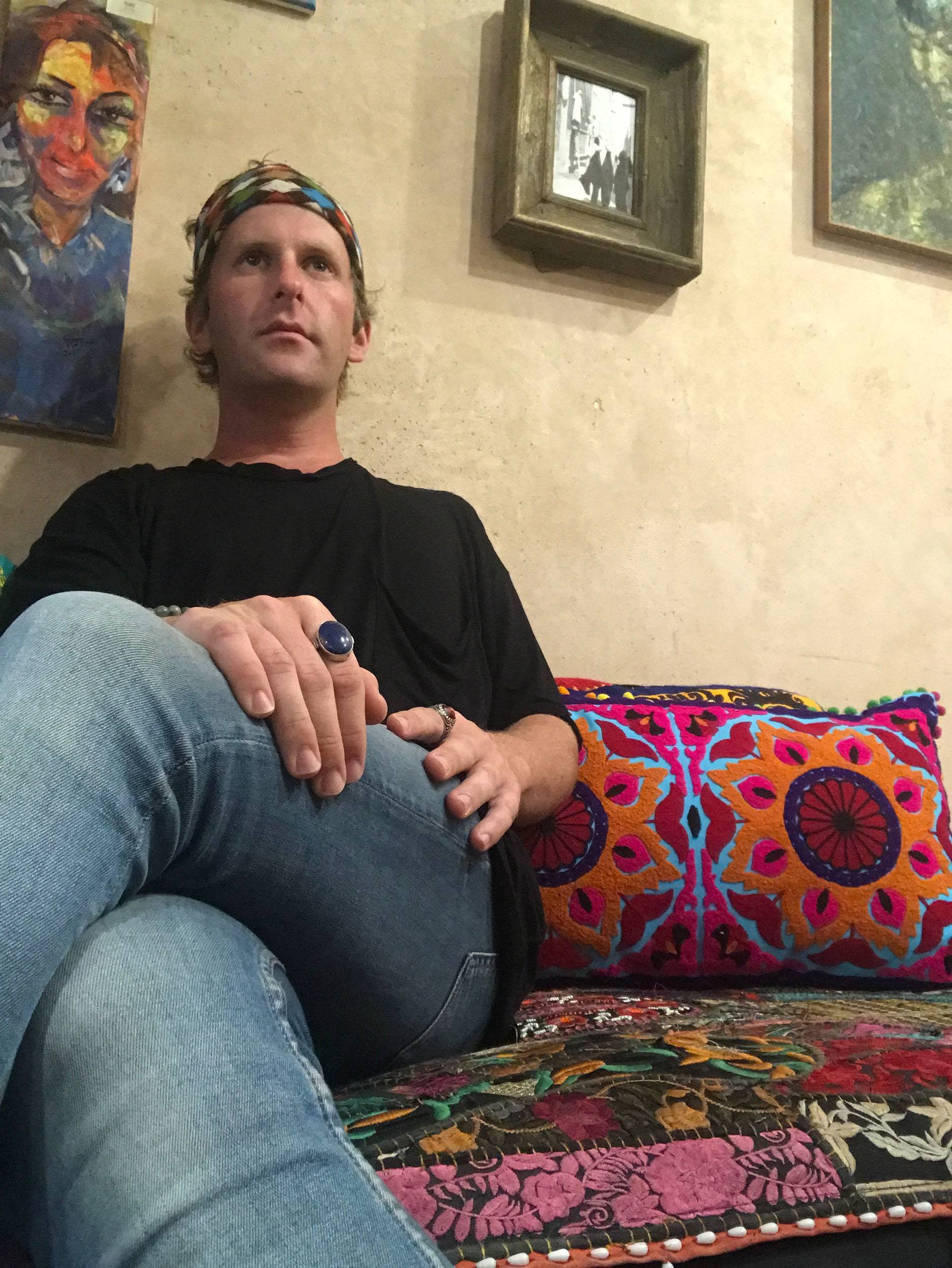 Ben on colourful couch in Beit Ahmed inside Souq Al-Mubarakiya Kuwait