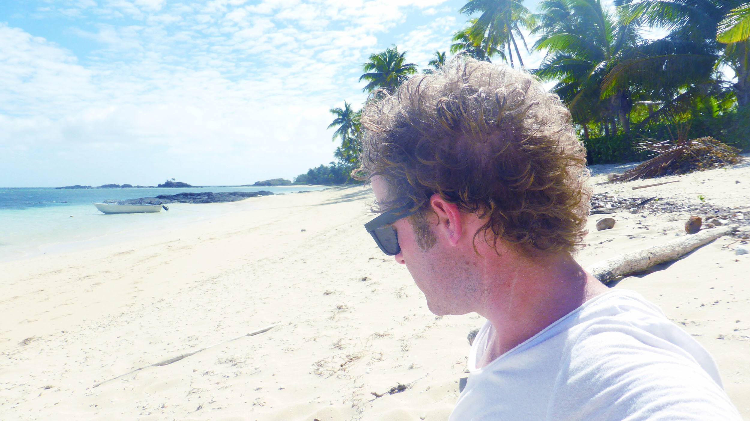 Ben on white-sand beach of Tavewa Island Fiji