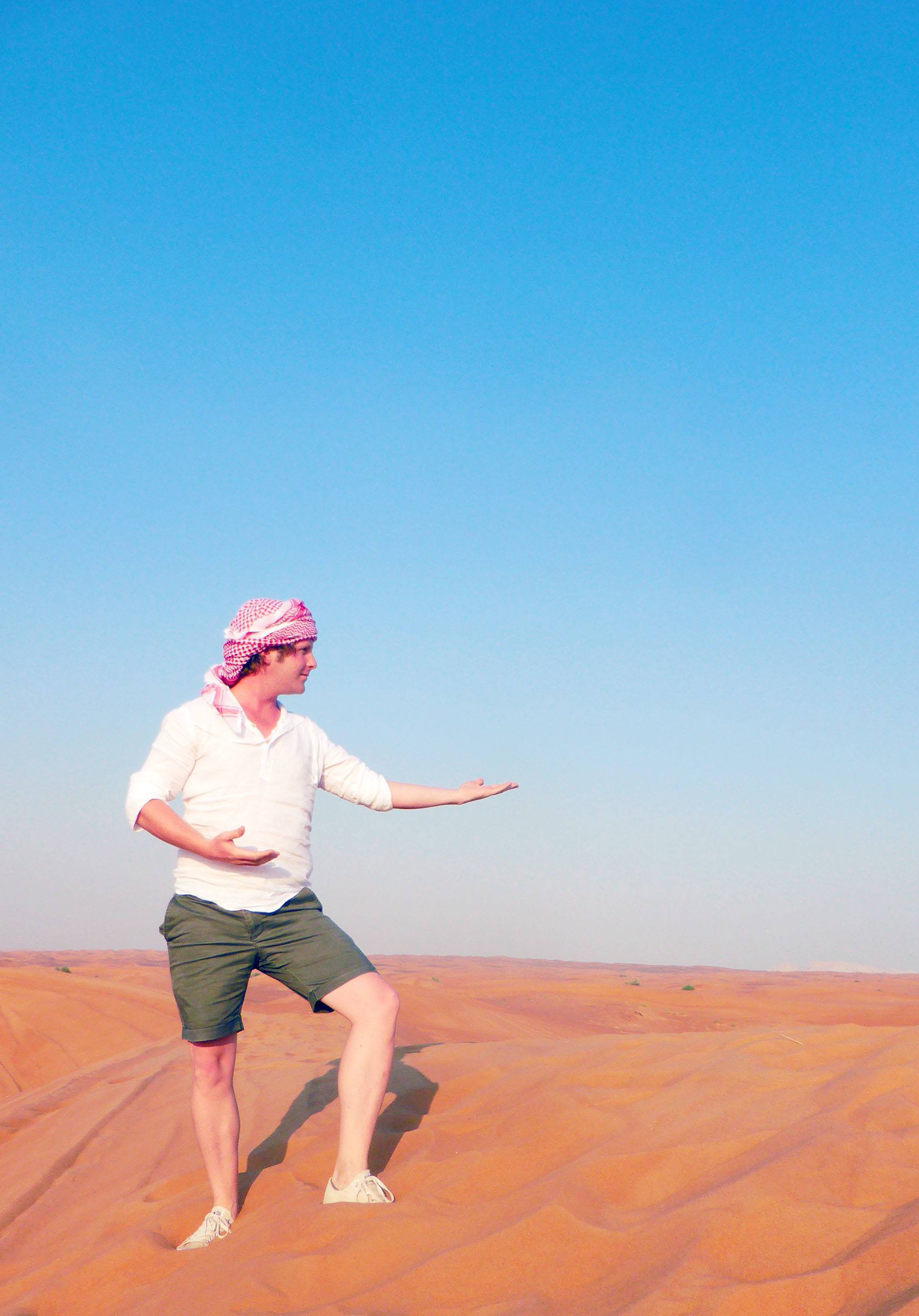 Ben posing in sand dunes near Dubai United Arab Emirates