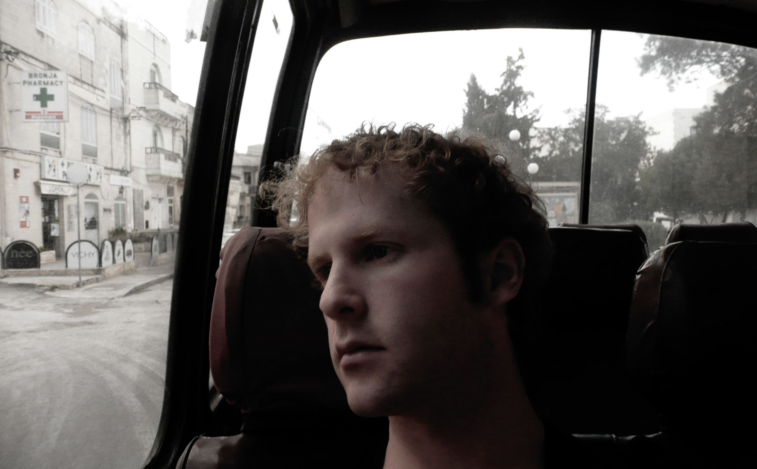 Ben riding orange public bus in Malta