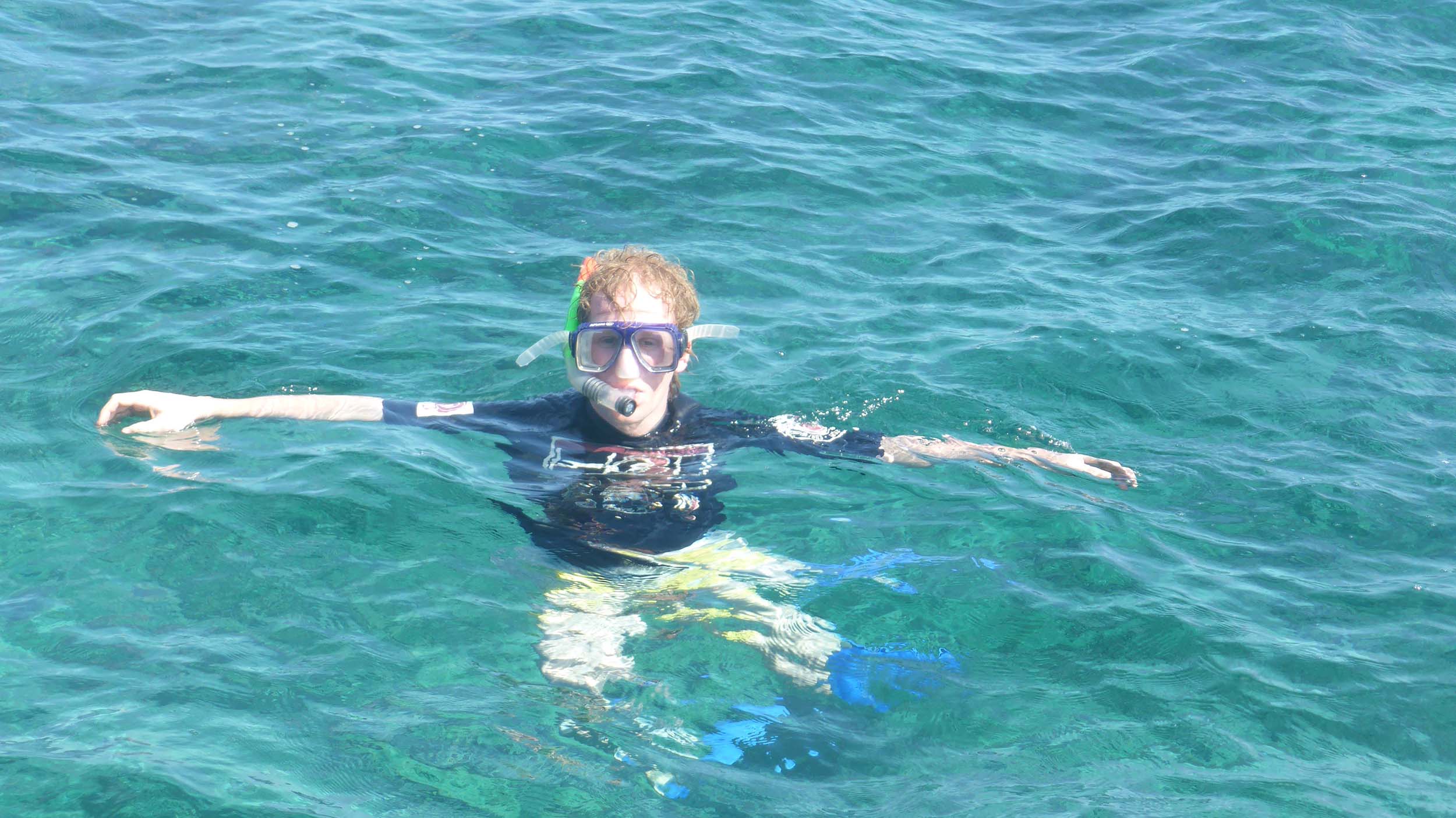 Ben snorkelling in emerald waters