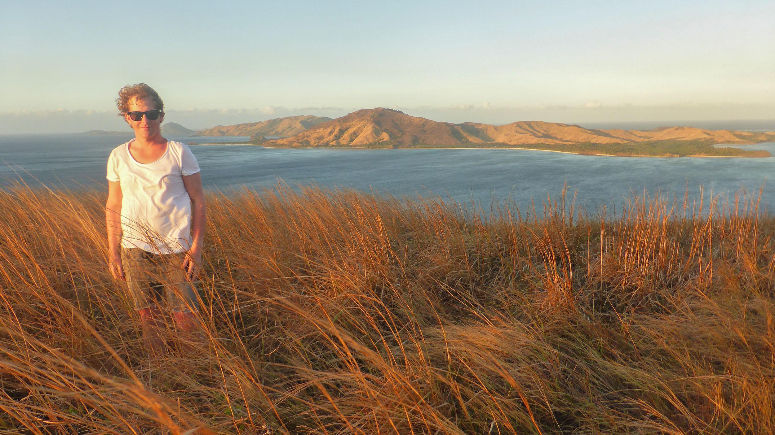 Ben standing at the highest point of Tavewa Island during sunset Fiji