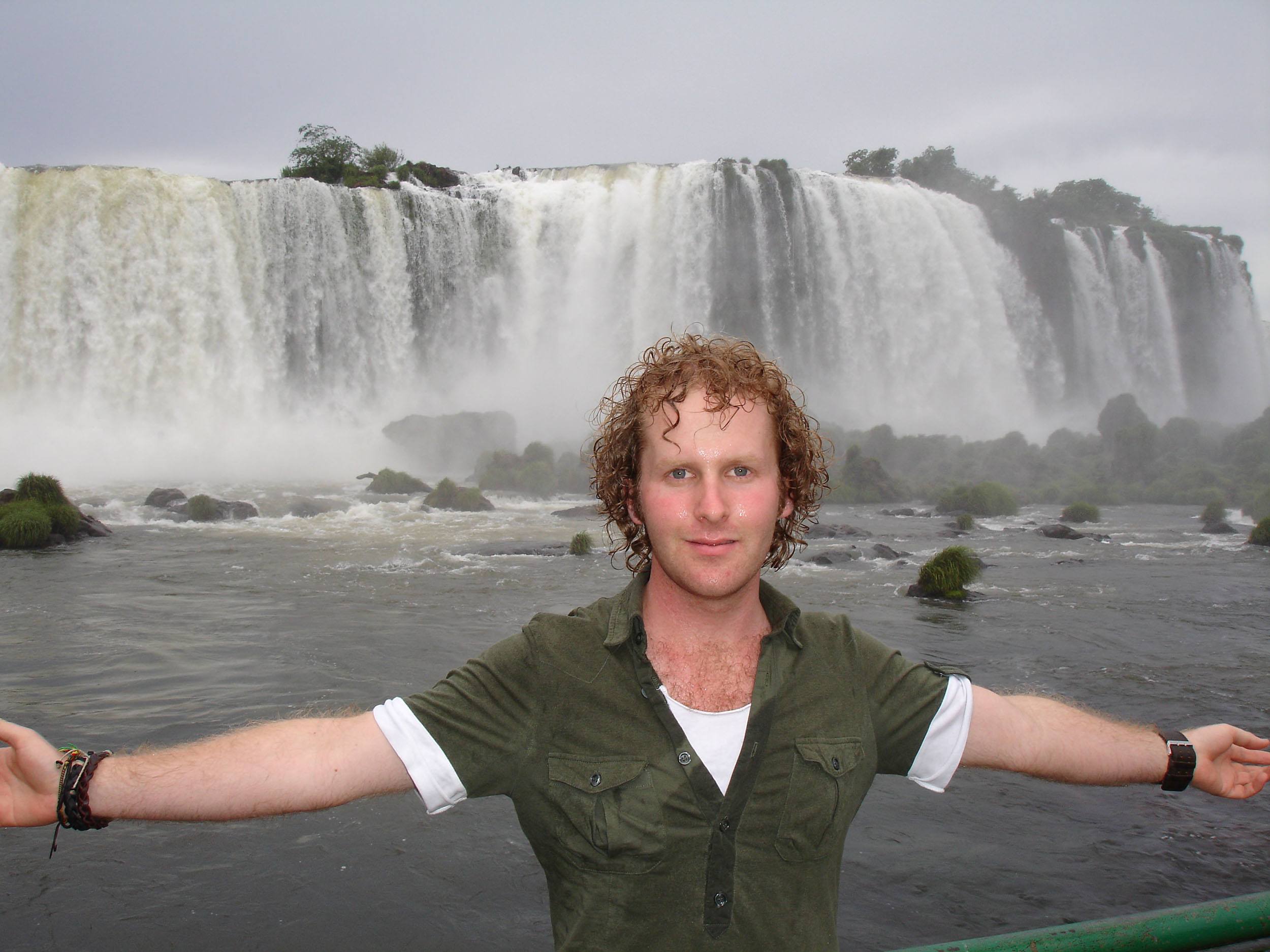 Ben standing in front of Iguazu Falls in Brazil