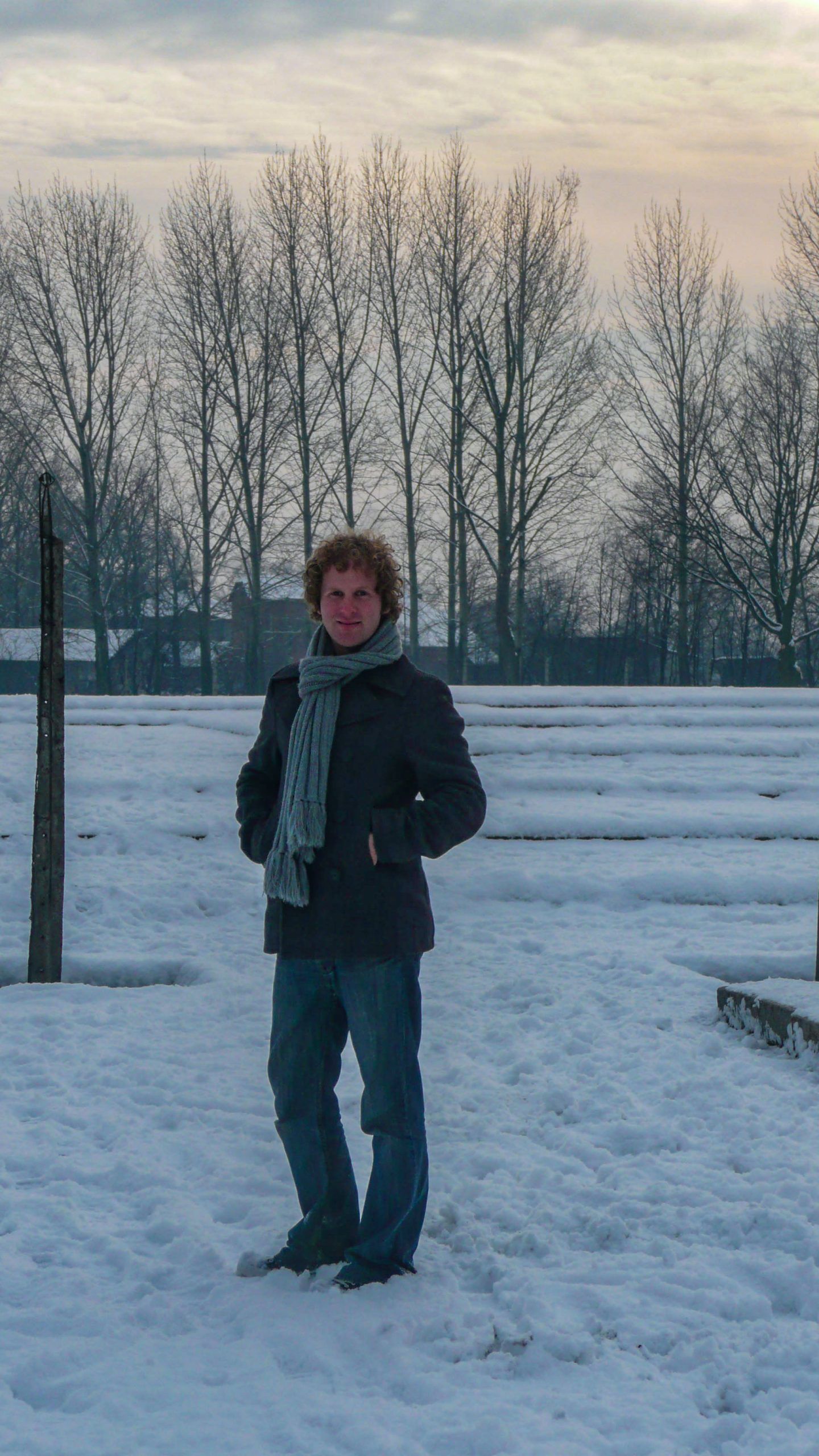 Ben standing in snow at Auschwitz concentration camp in Poland