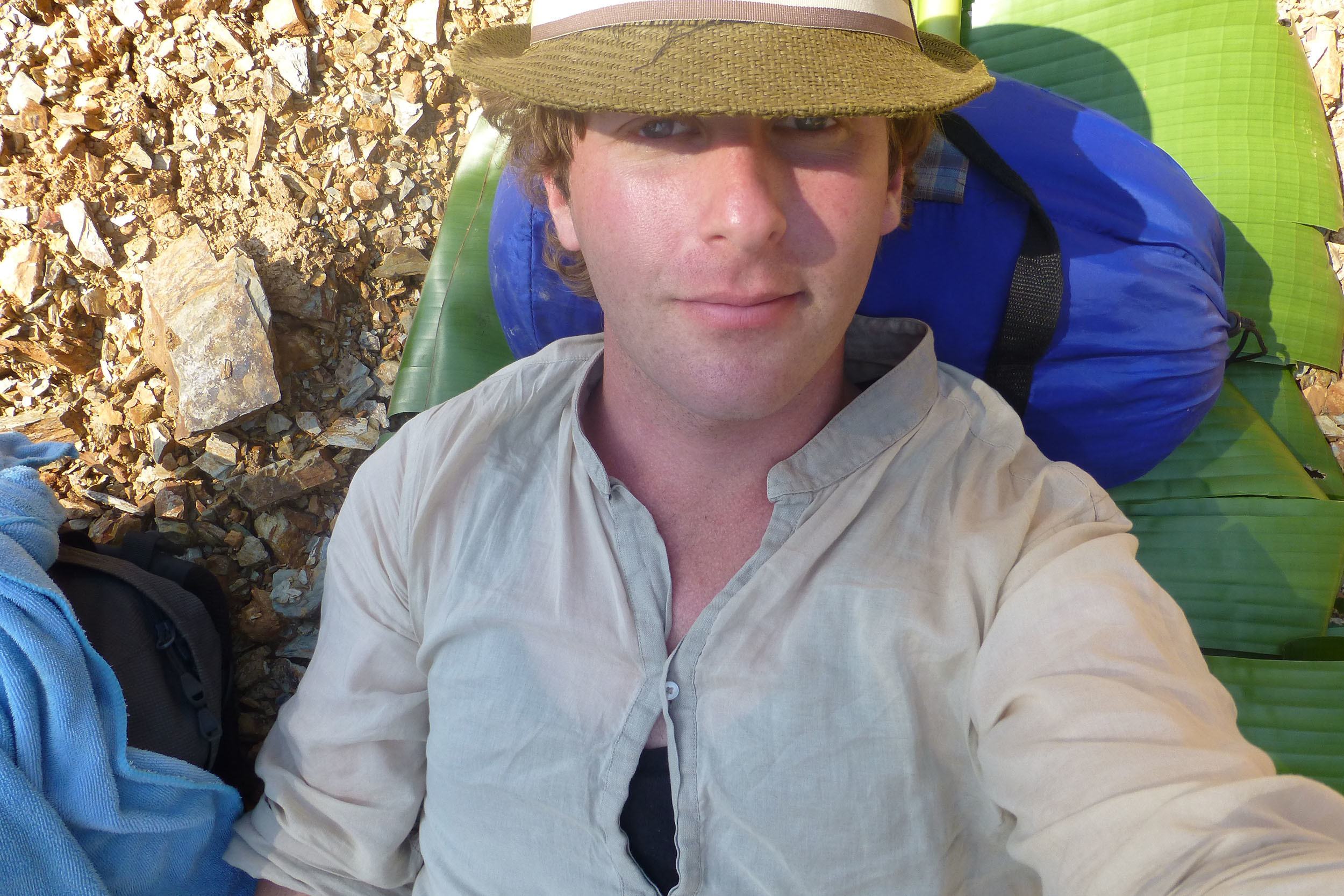 Ben taking a rest on a large banana leaf on trek in Laos