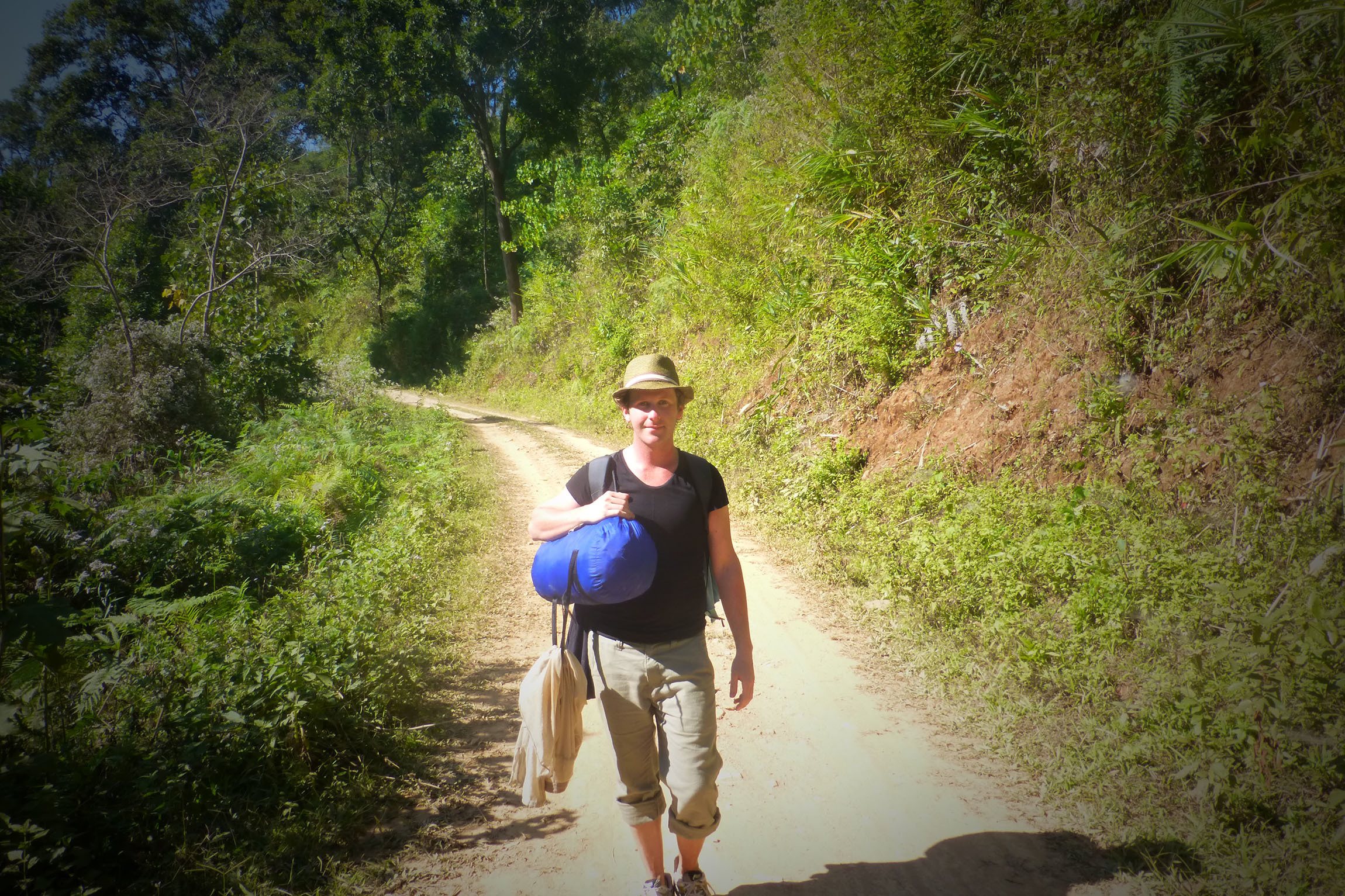 Ben walking toward Akha village following jungle trek Laos