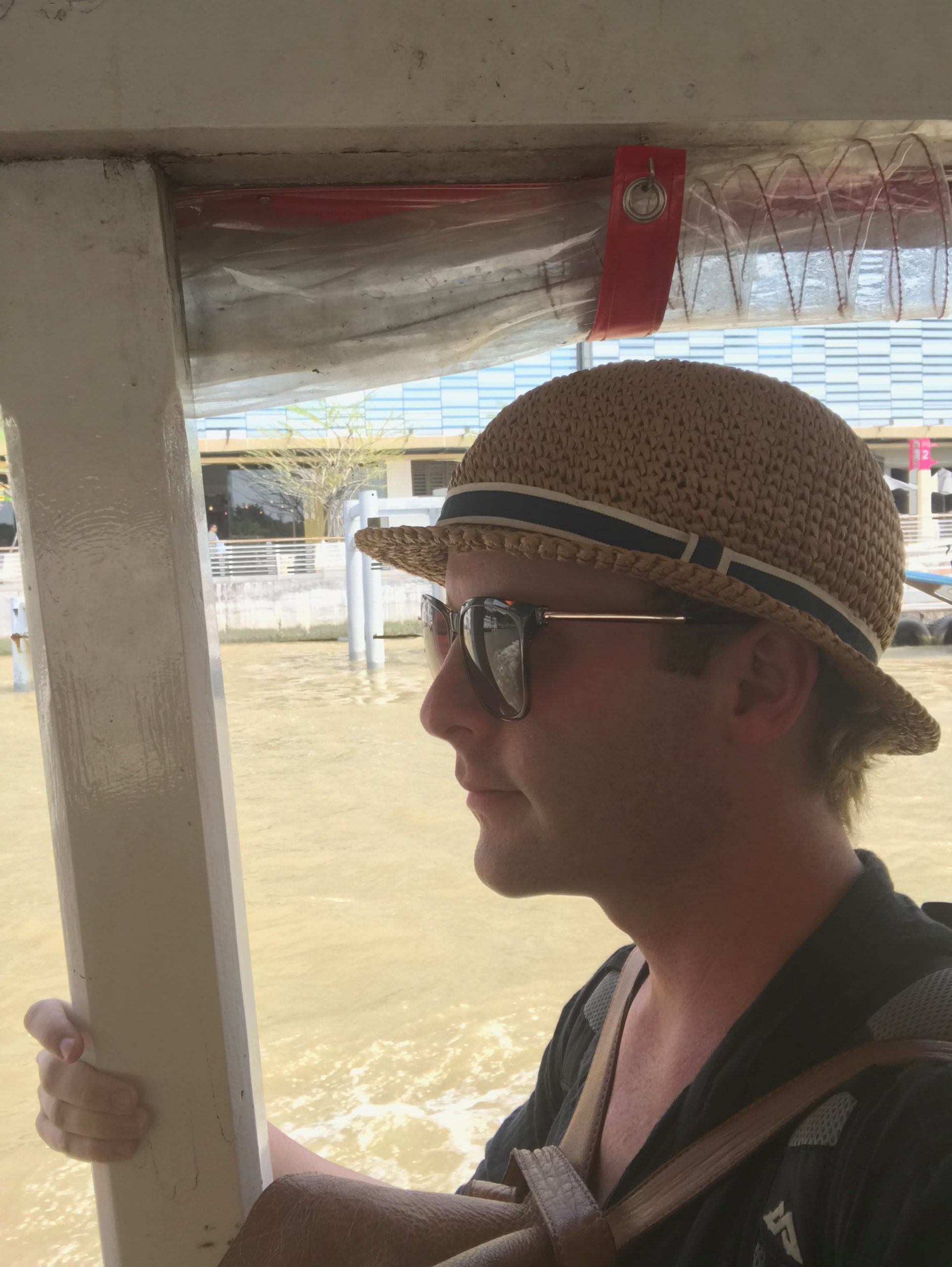 Ben with Kathmandu backpack on boat in Thailand