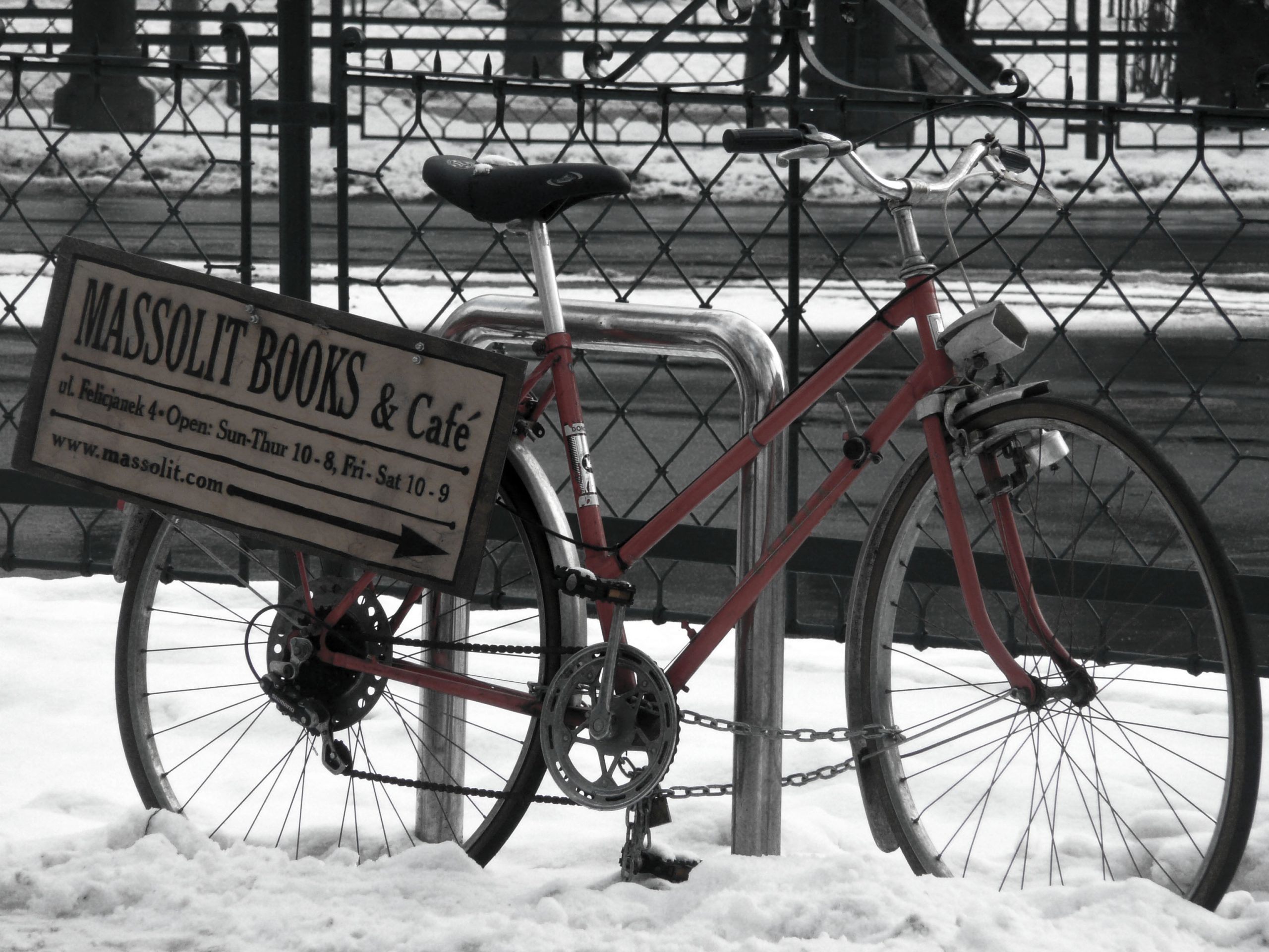 Bicycle in the snow leaning against a fence in Krakow Poland