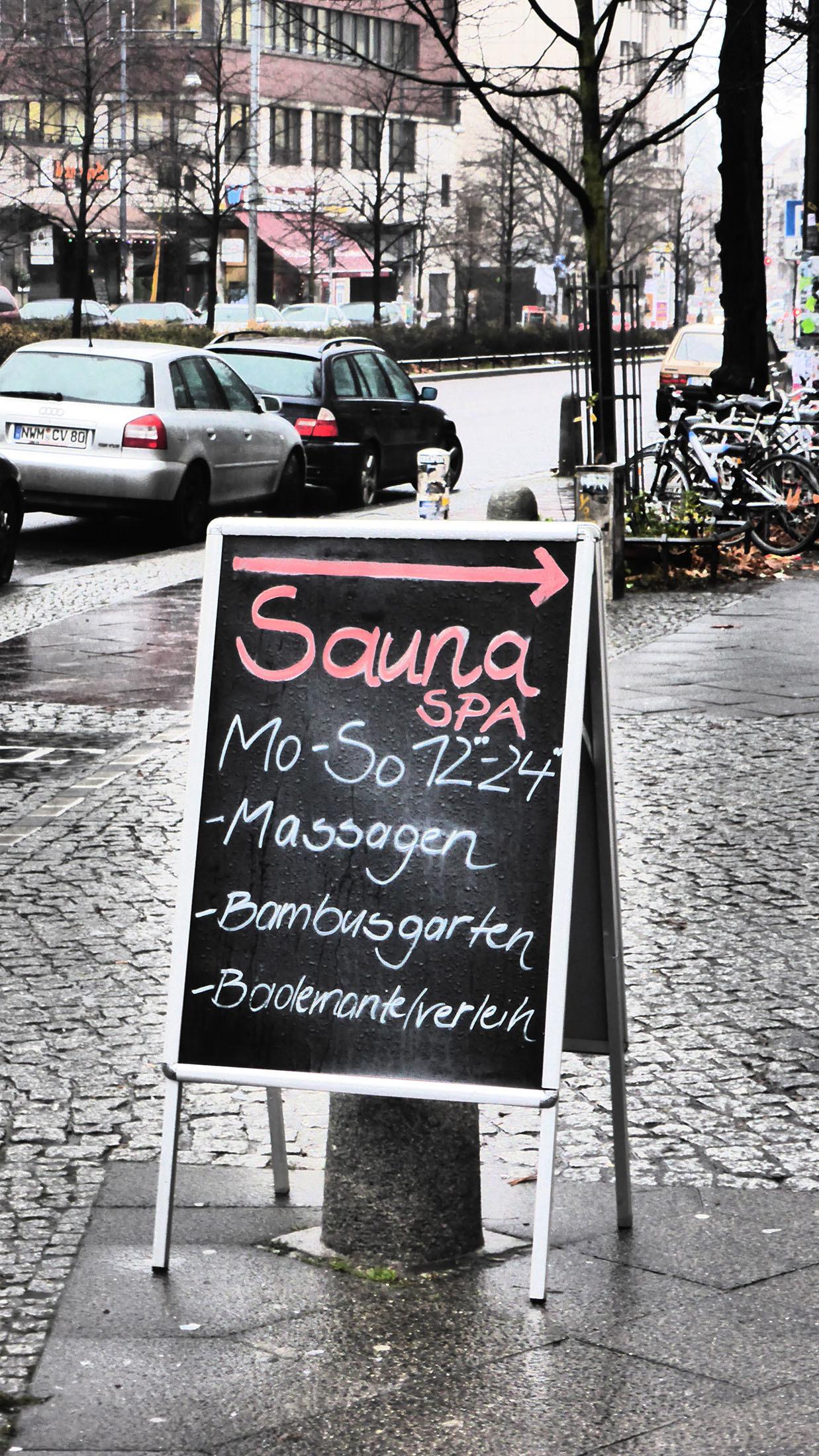 Board advertising Oliving Wellness Lounge Sauna in Berlin Germany