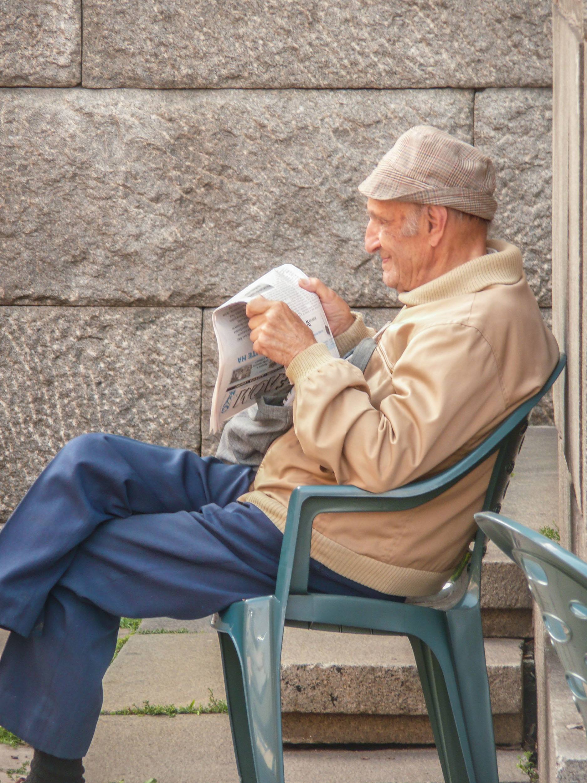 Bulgarian man reading newspapar near park in Sofia Bulgaria