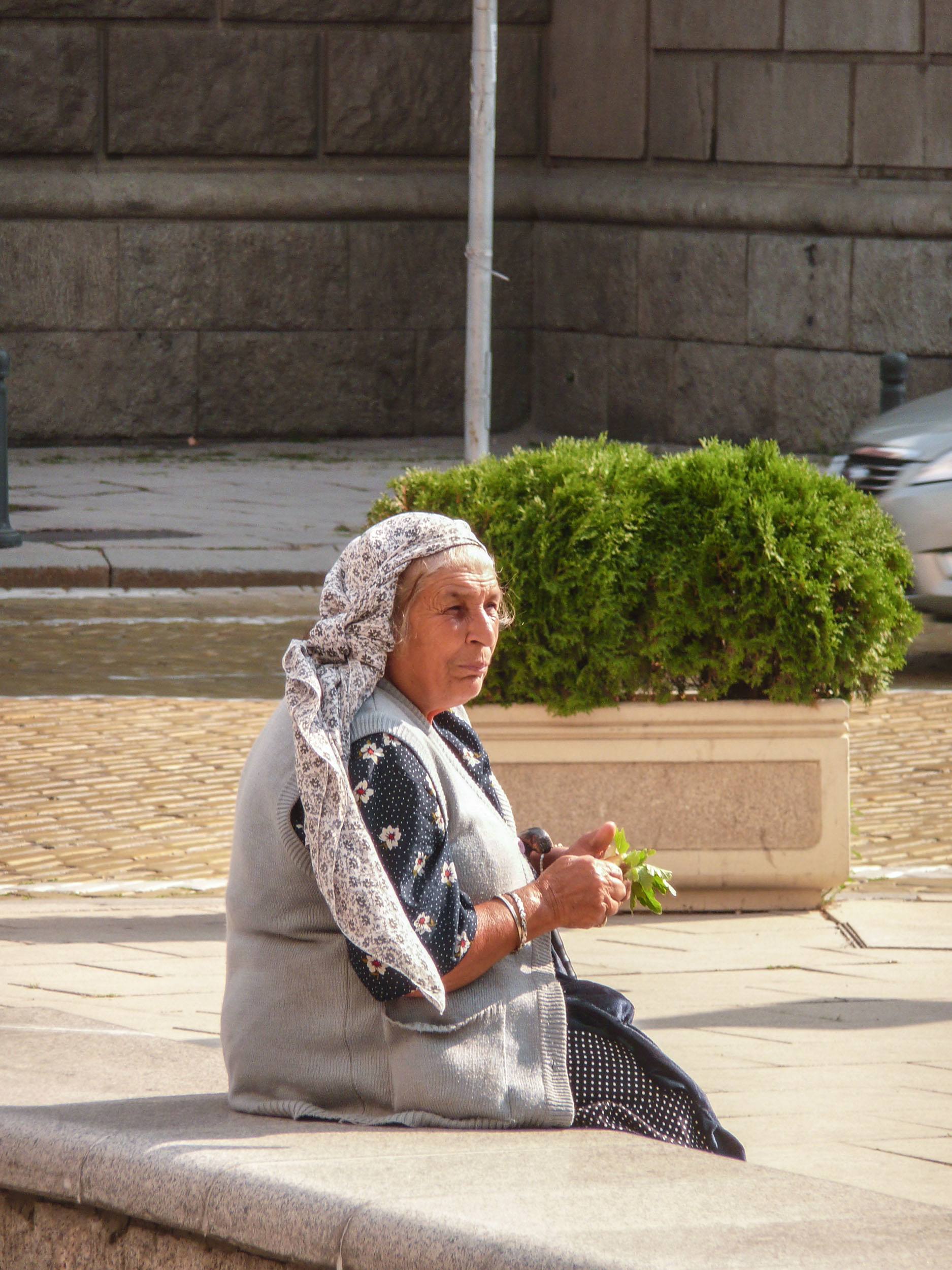 Bulgarian woman sitting on park bench in Sofia Bulgaria