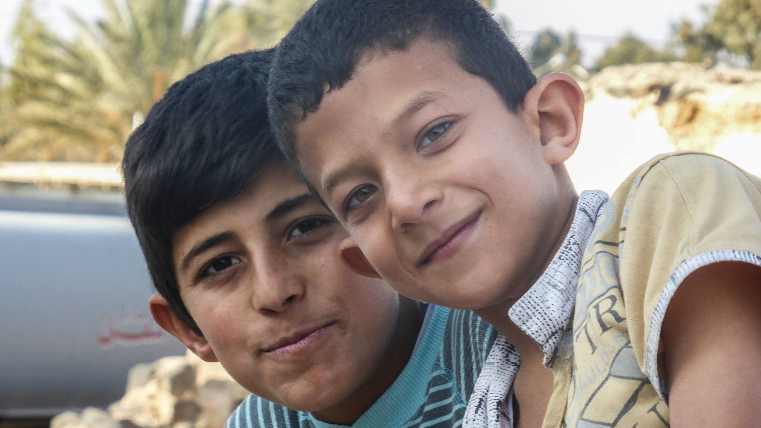 Children posing outside Qasr Al Azraq Jordan