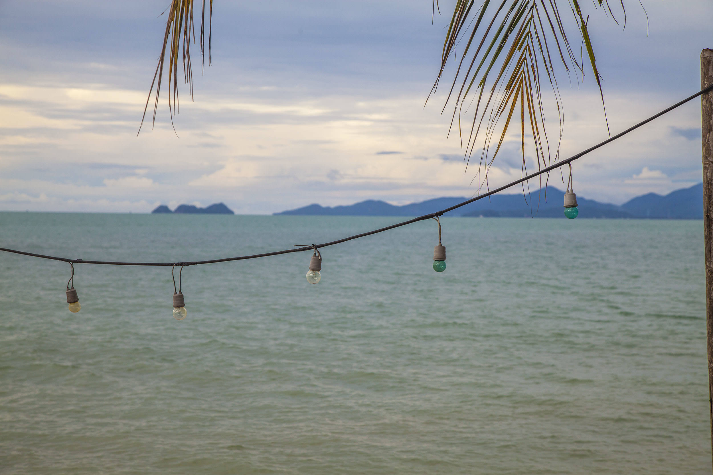 Coloured light bulbs hanging across Bang Po Beach Koh Samui Thailand