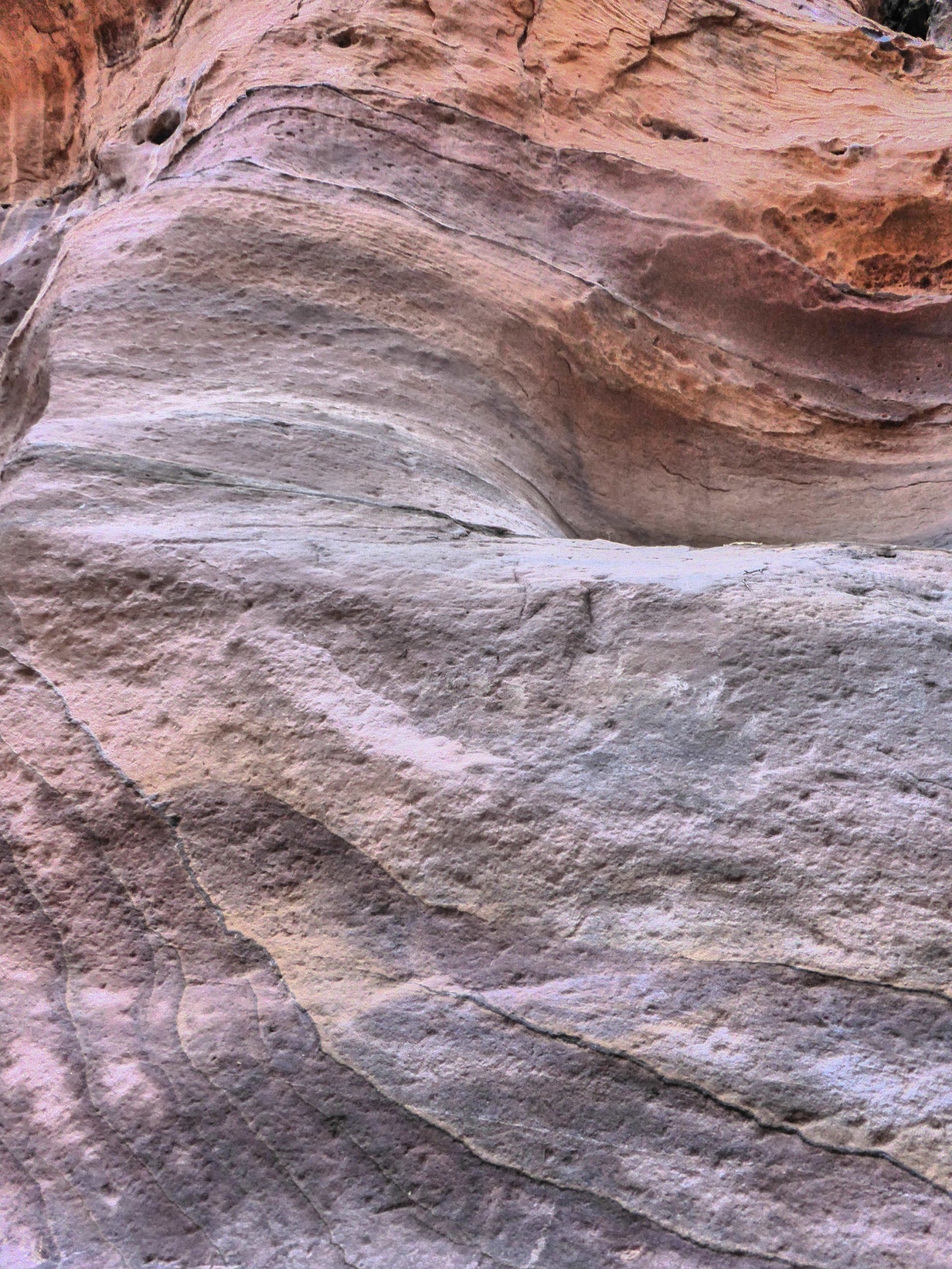 Colourful stone walls of walkway leading to the Treasury of Petra Jordan