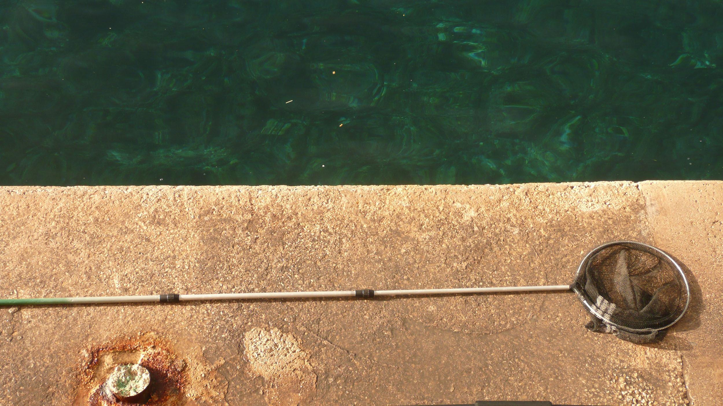 Fishing net on pole lying on concrete in Valletta Malta